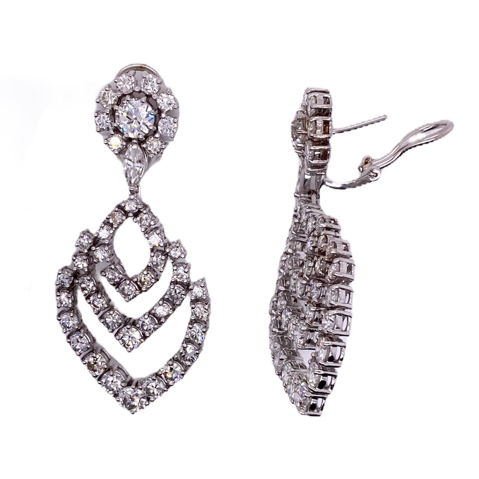Stunning diamond drop earrings fashioned in 18 karat white gold. The earrings feature 88 round brilliant cut diamonds weighing approximately 9.00 carat total weight. The diamonds are graded F-G color and VS2-SI1 clarity. The earrings measure 2.0