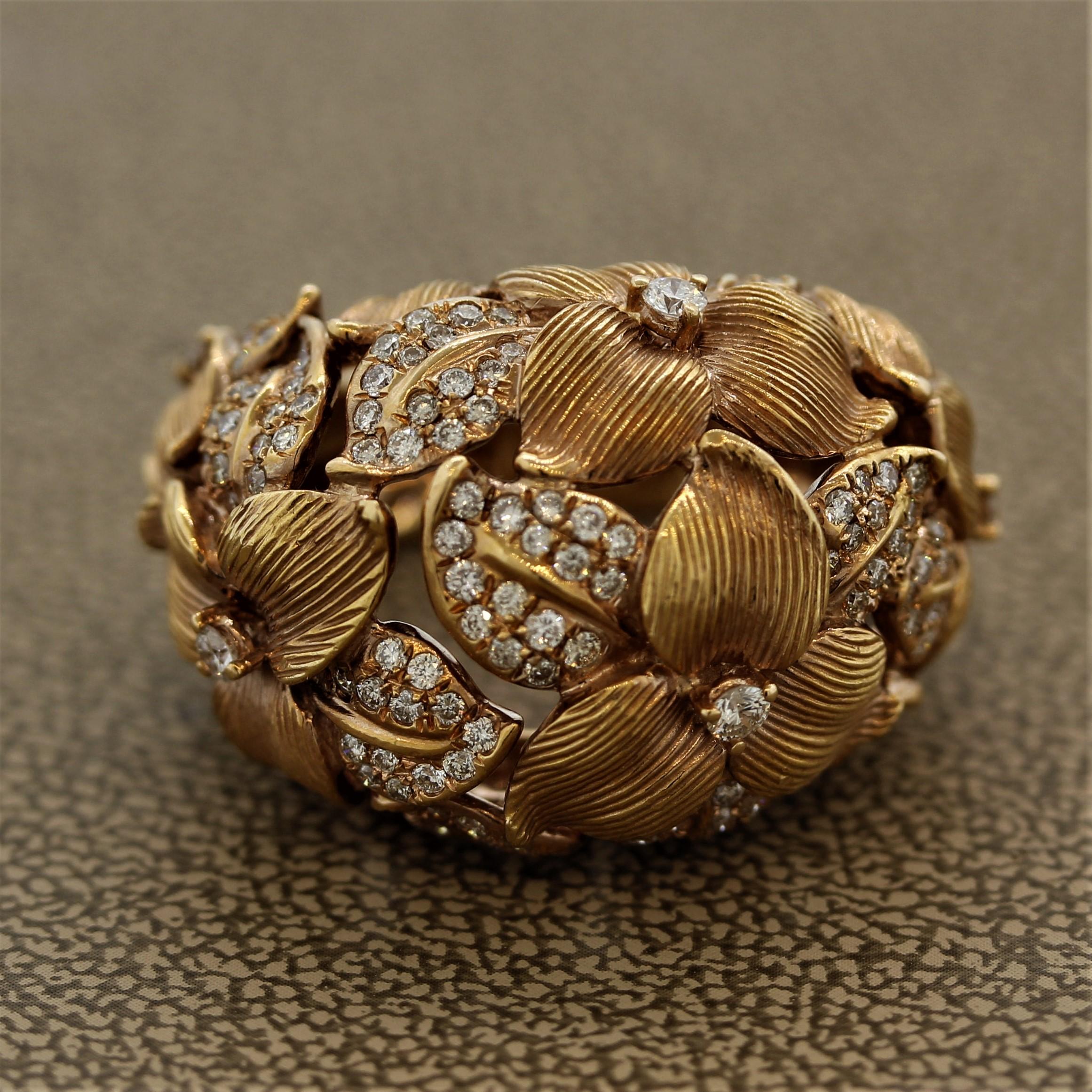 An exceptional ring handcrafted in 18k rose gold. It depicts a floral scene with diamond studded foliage. The piece features 1.17 carats of round brilliant cut diamonds which are set across hand carved foliage and flowers. The pedals of the flowers