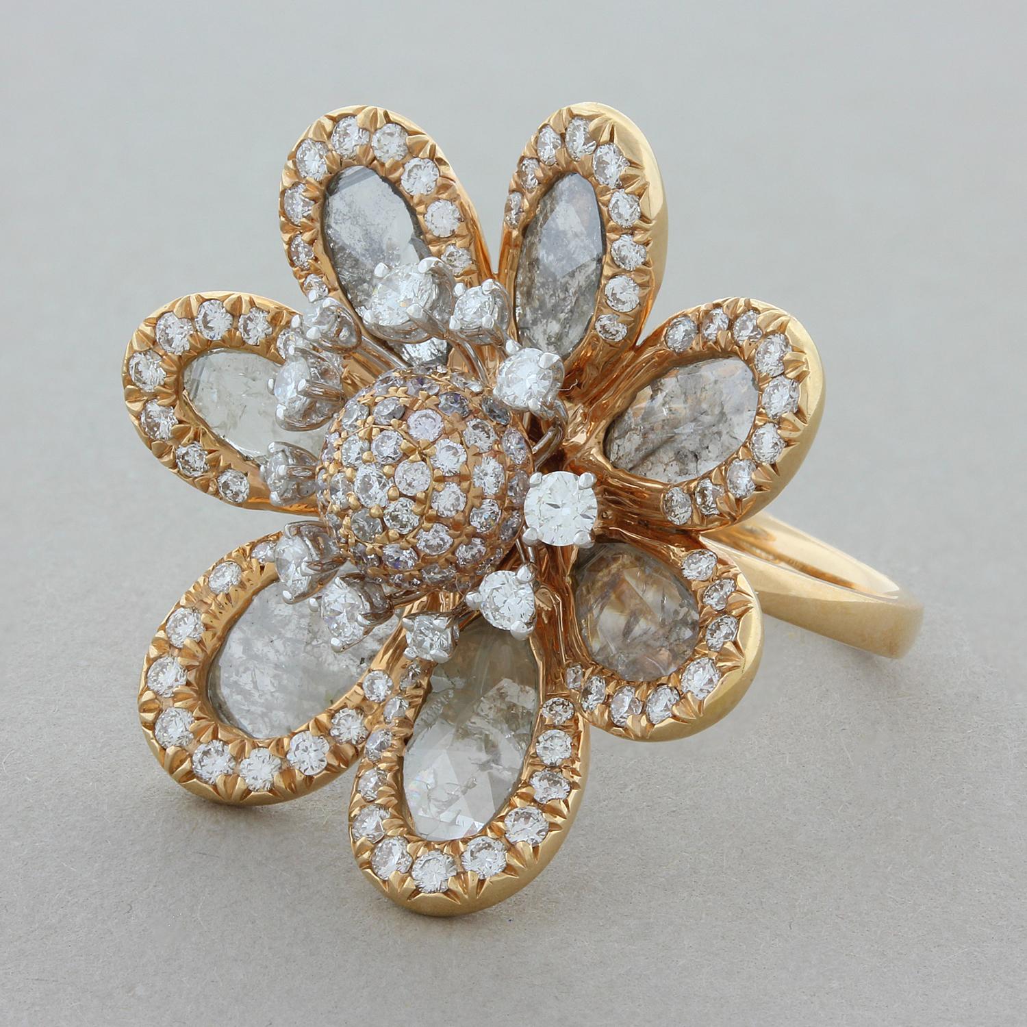 This flower cocktail ring featuring 4.53 carats of rose cut diamond slices for petals with full round cut diamonds haloing each petal as well as for the stamens in the center along with pave set diamonds. This exceptional ring is set in 18K rose