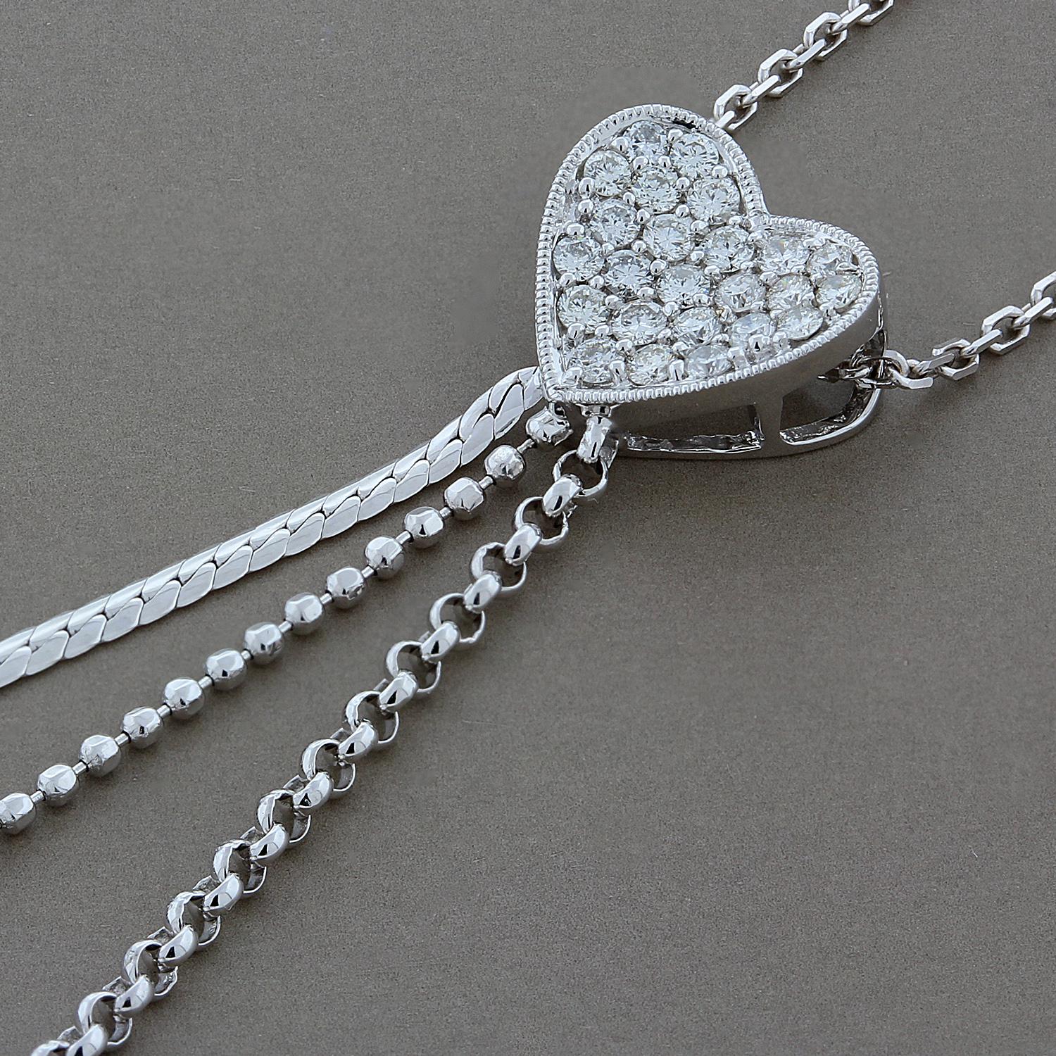 I give you my heart! A concave heart pendant studded with 0.32 carats of round cut colorless VS quality diamonds with a milgrain border. The heart has a special tri-strand gold drop, with each strand in a different gold style, texture and length
