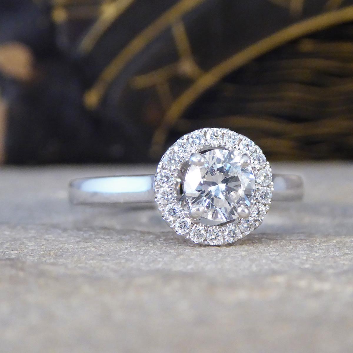 A beautiful and bright Diamond halo cluster ring set in platinum. This exquisite piece features a lovely 0.50ct re-homed stone at its centre, cut to perfection in a Brilliant Cut style, giving it the second hand price appeal with a brand new setting