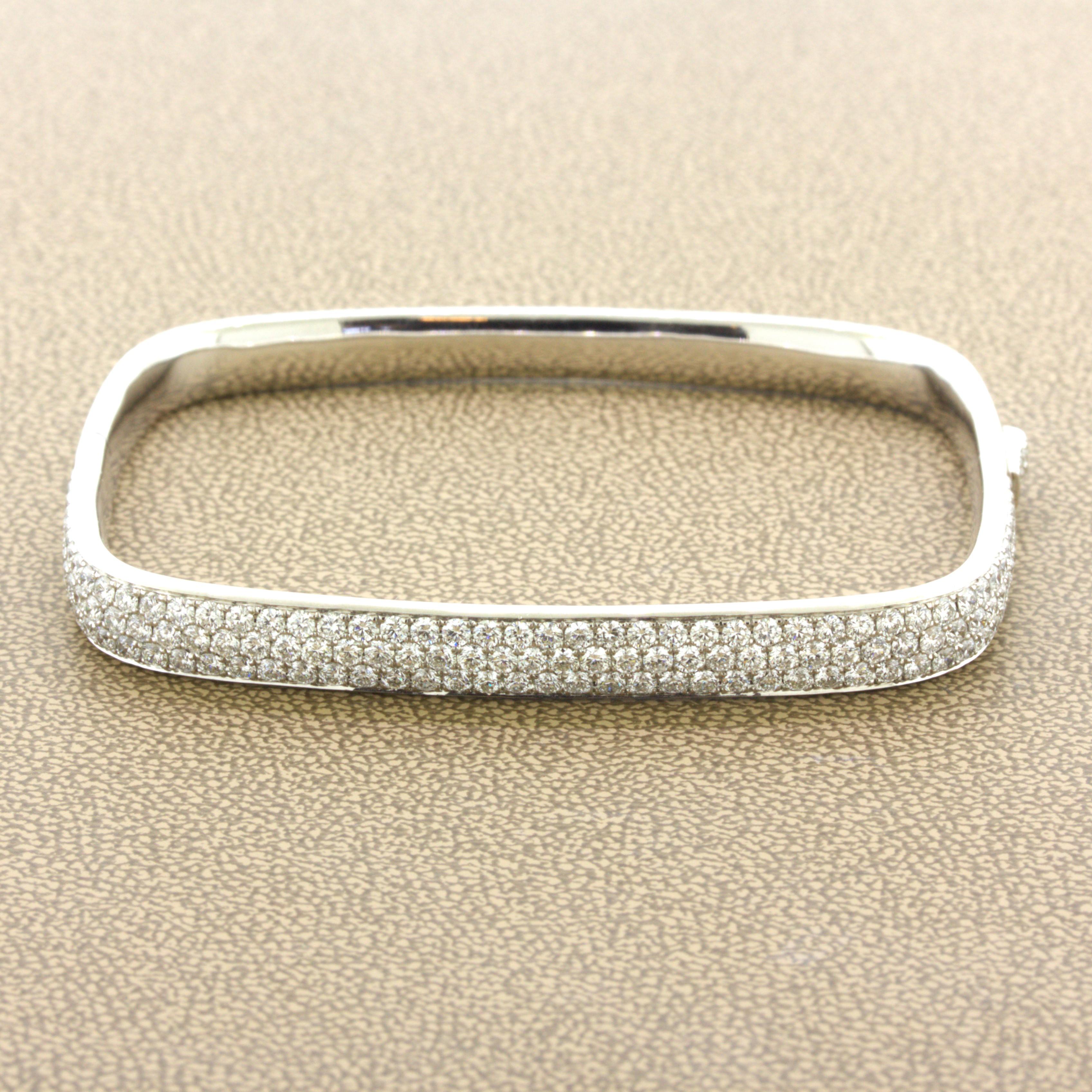 A chic and elegant diamond pave bangle with a modern design. While most bangles are rounded this piece is more squarish in shape with rounded corners. It features 3.85 carats of bright white VS quality diamonds pave-set over the top half of the