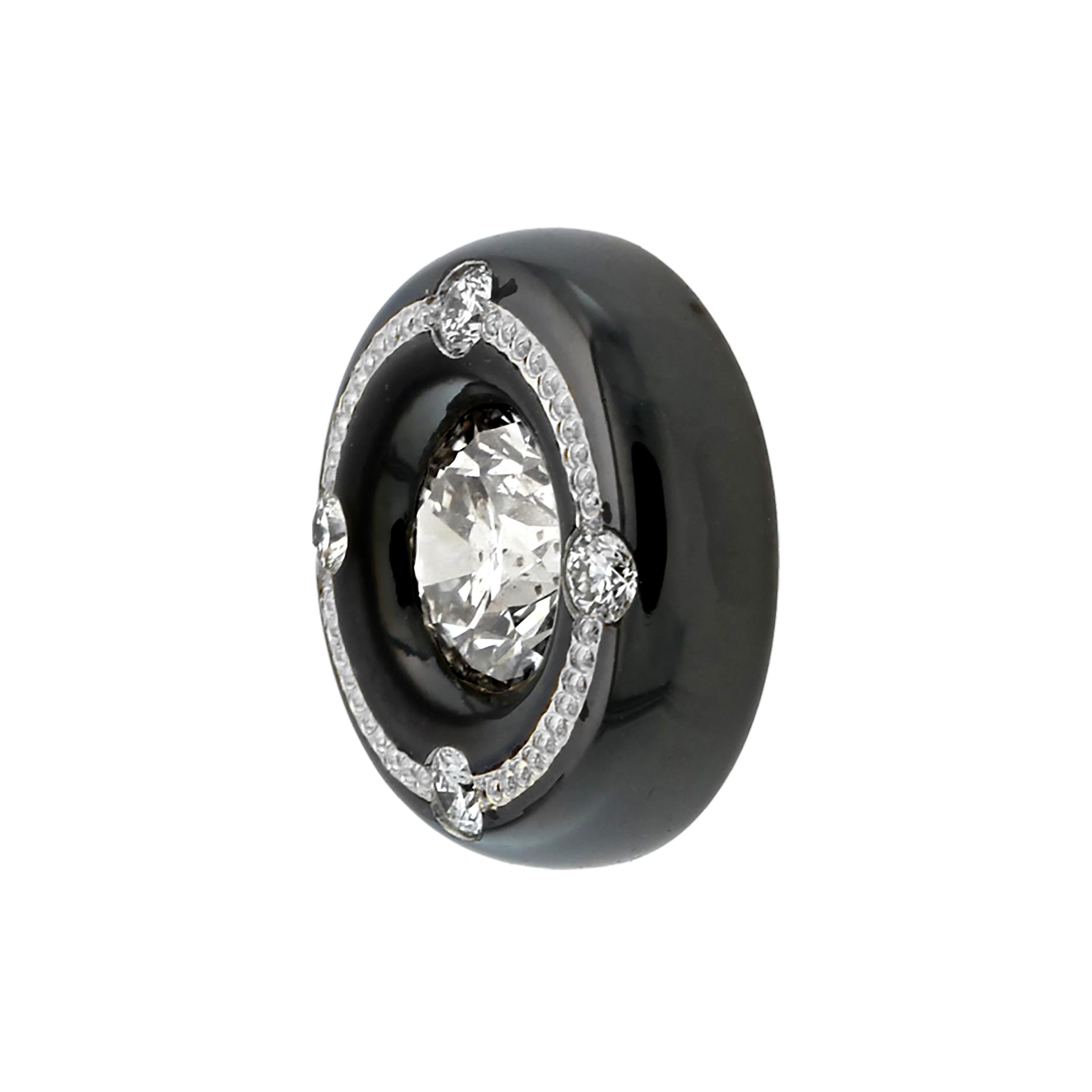 Not your basic diamond stud earrings! These diamonds are set in a round high gloss black Knightsteel setting with a line of pure platinum hand engraved shaped inlay going around the top. There are also four .01 ct. round brilliant diamonds bead set