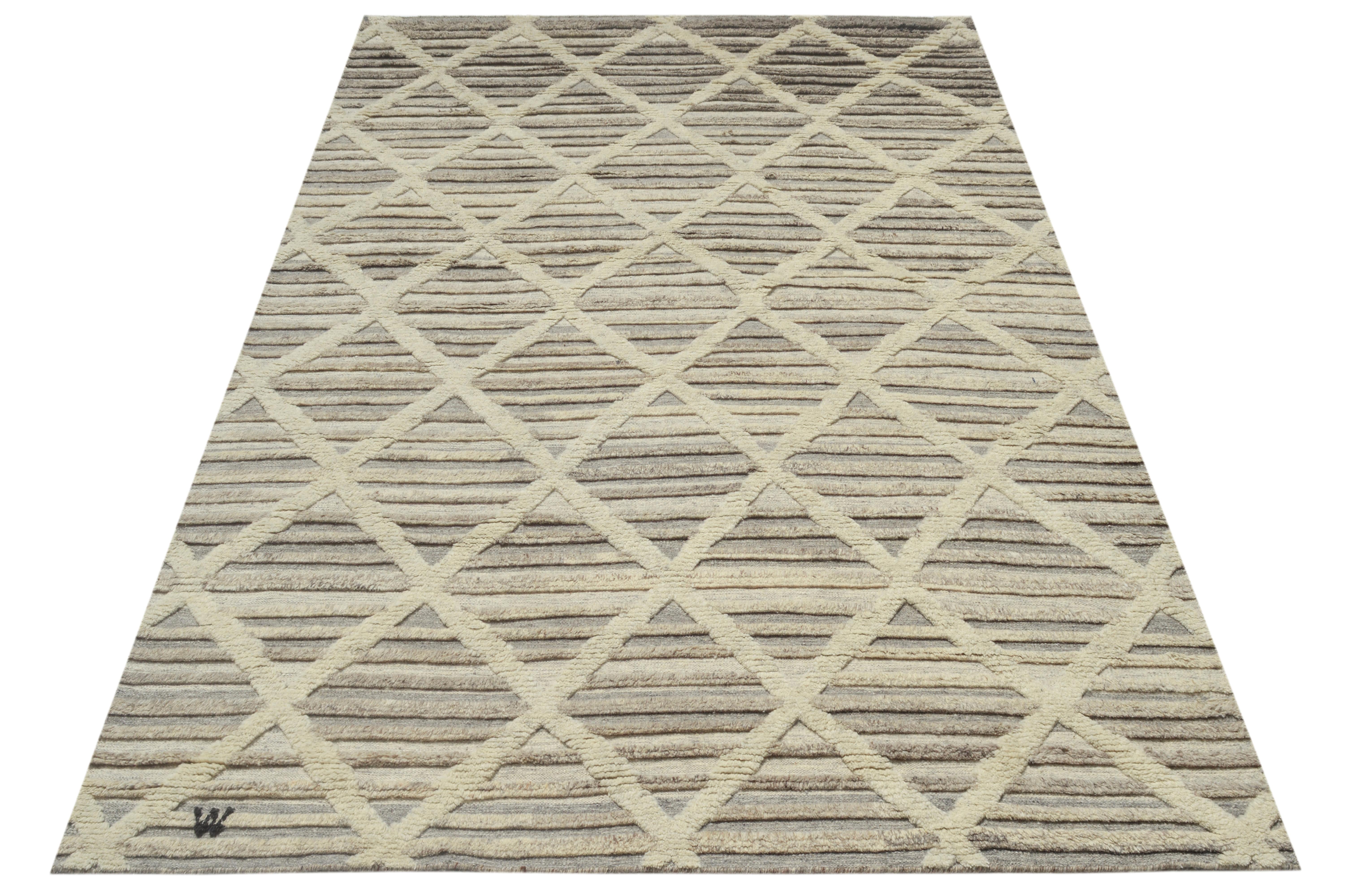 Hand-knotted wool pile on a cotton foundation.

High-low pile design.

Approximate Dimensions: 9' x 12'

Origin: India

Field Color: Ivory. 

Accent Color: Grey.