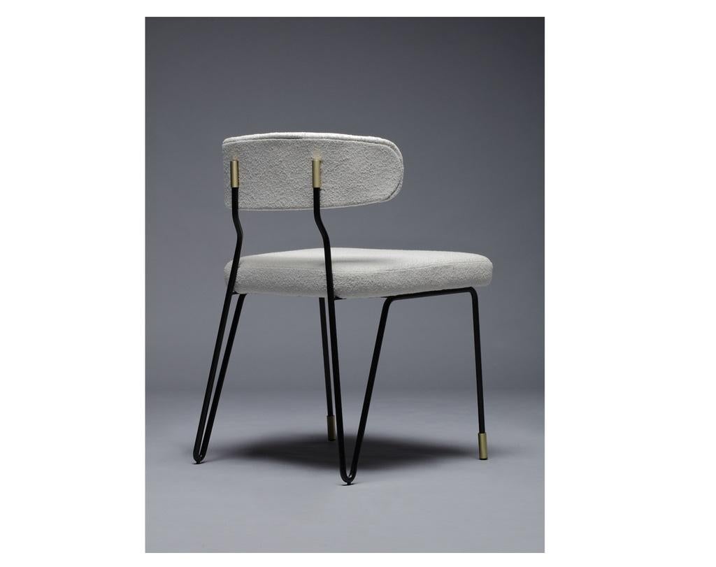 Combining high levels of comfort and style, this chair has a stellar design inspiration. The metal continuous structure creates a sleek base with brushed brass accents. Upholstered in beige fabric, color as shown H864. 
Dimensions:
Width 50.5 cm