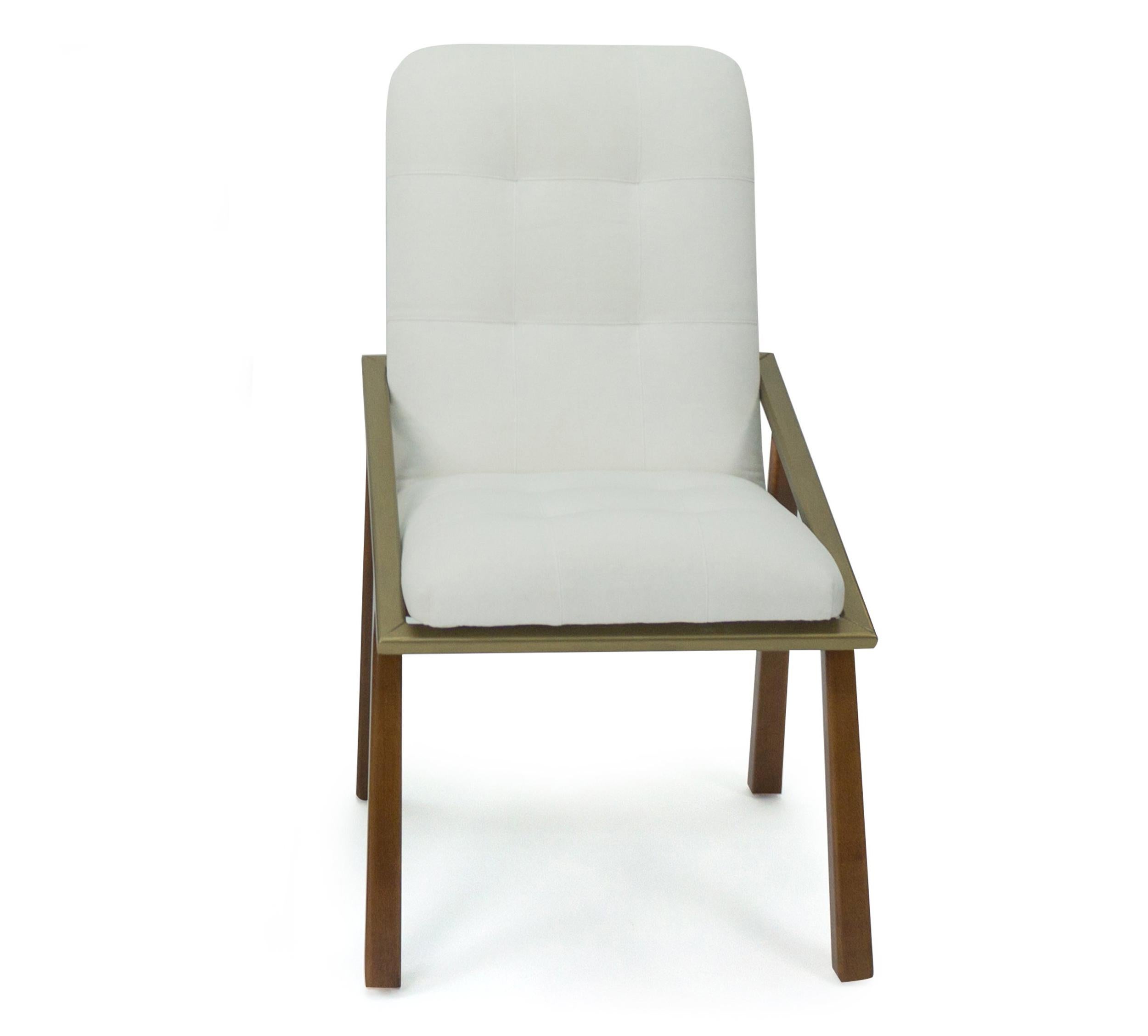 This modern built to order dining chair is designed by us and manufactured in CT. The slightly flared legs are constructed of maple and finished in a light honey walnut stain. On the exterior is an angled rectangular satellite painted in metallic