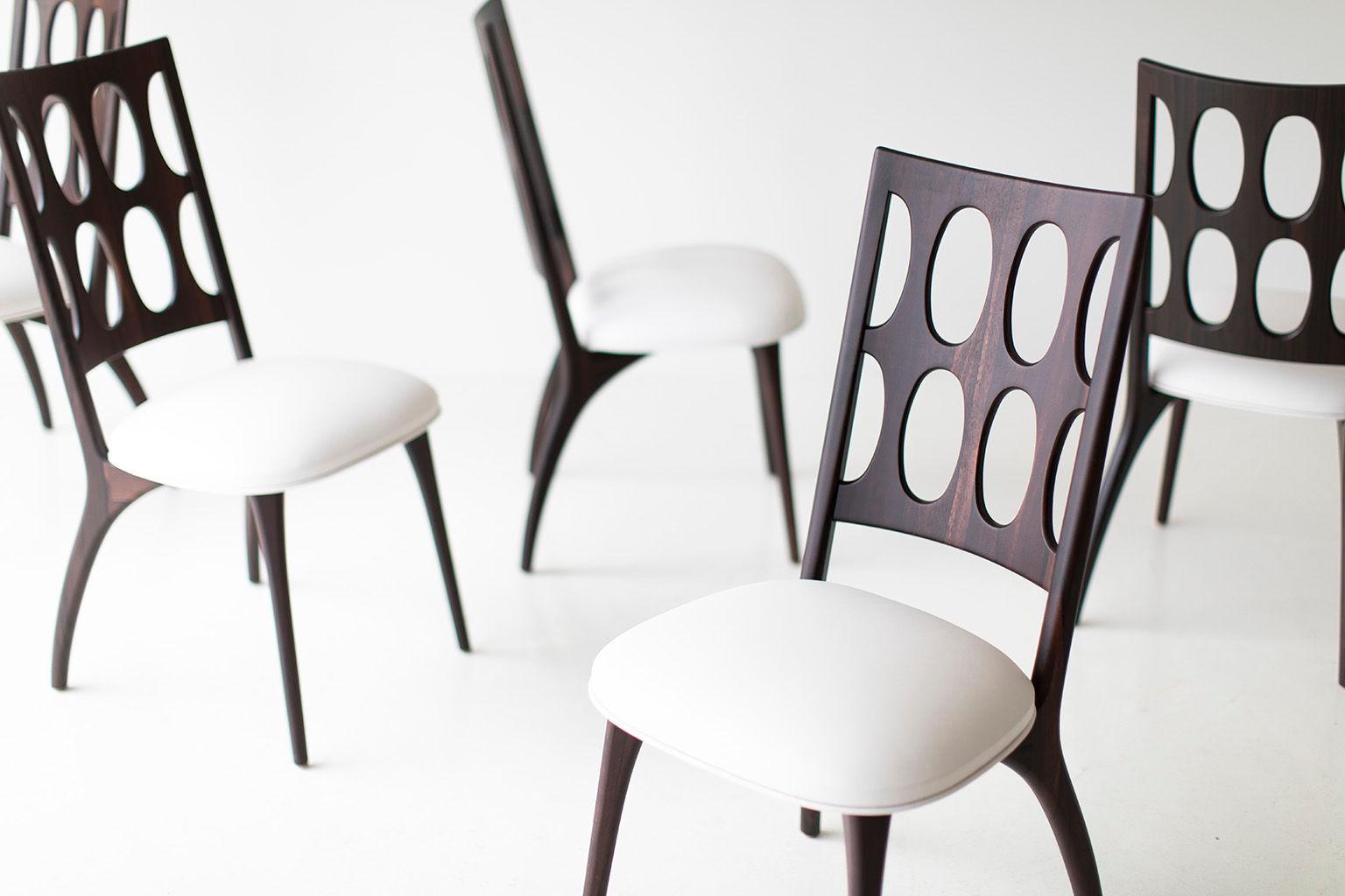 Modern dining chairs, 1901 for Craft Associates Furniture are expertly handcrafted. Each chair base is constructed by hand from hard wood. The chairs shown are in ziricote, and shaped by artisans and finished with a commercial grade matte finish.