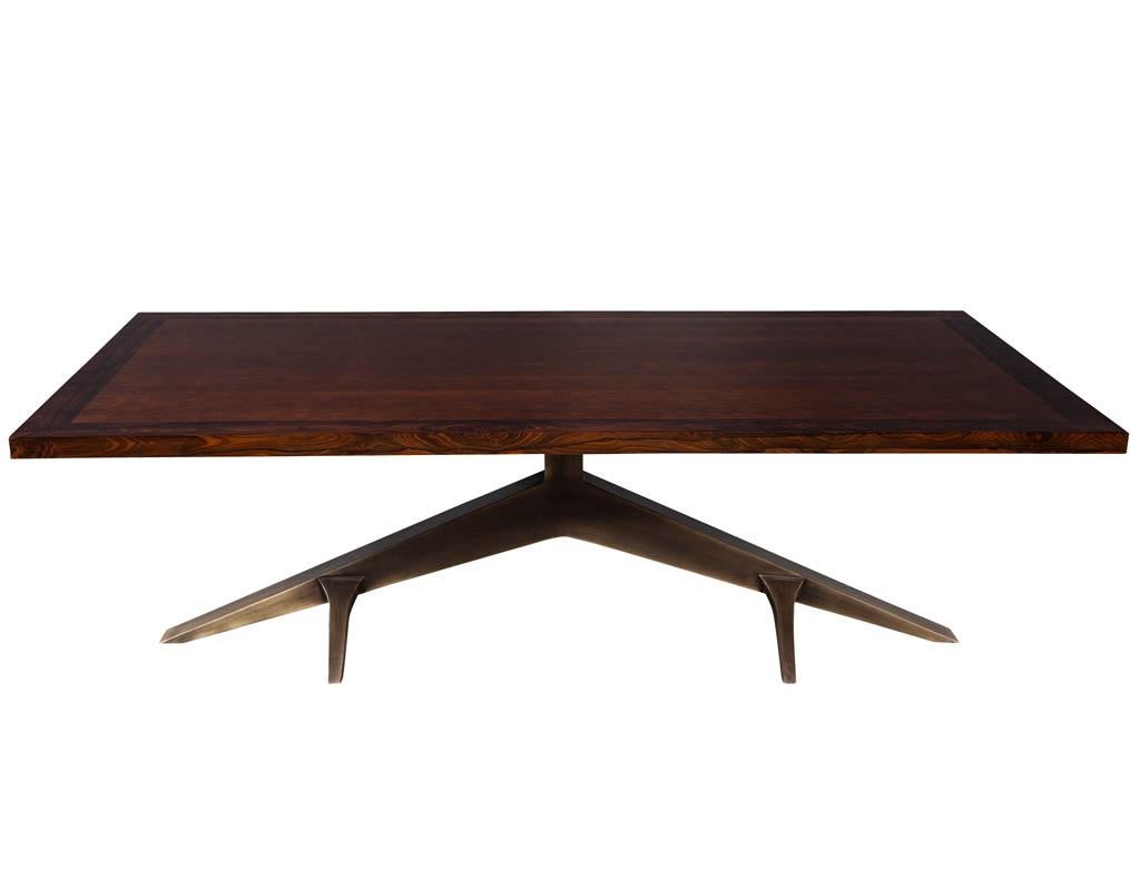 Modern dining table with unique metal base Mozambique and Circassia Banded. Modern dining table with an antique brass tree limb designed base with a Mozambique and Circassia banded top.

Price includes complimentary scheduled curb side delivery