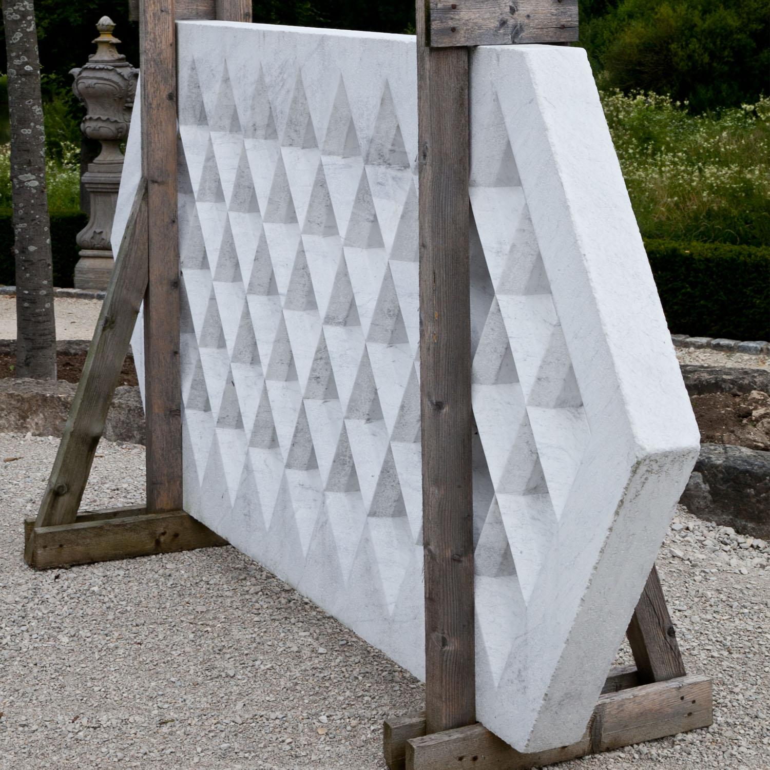 Modern hexagonal divider with a rhomboid grid pattern, carved in one piece out of white marble.