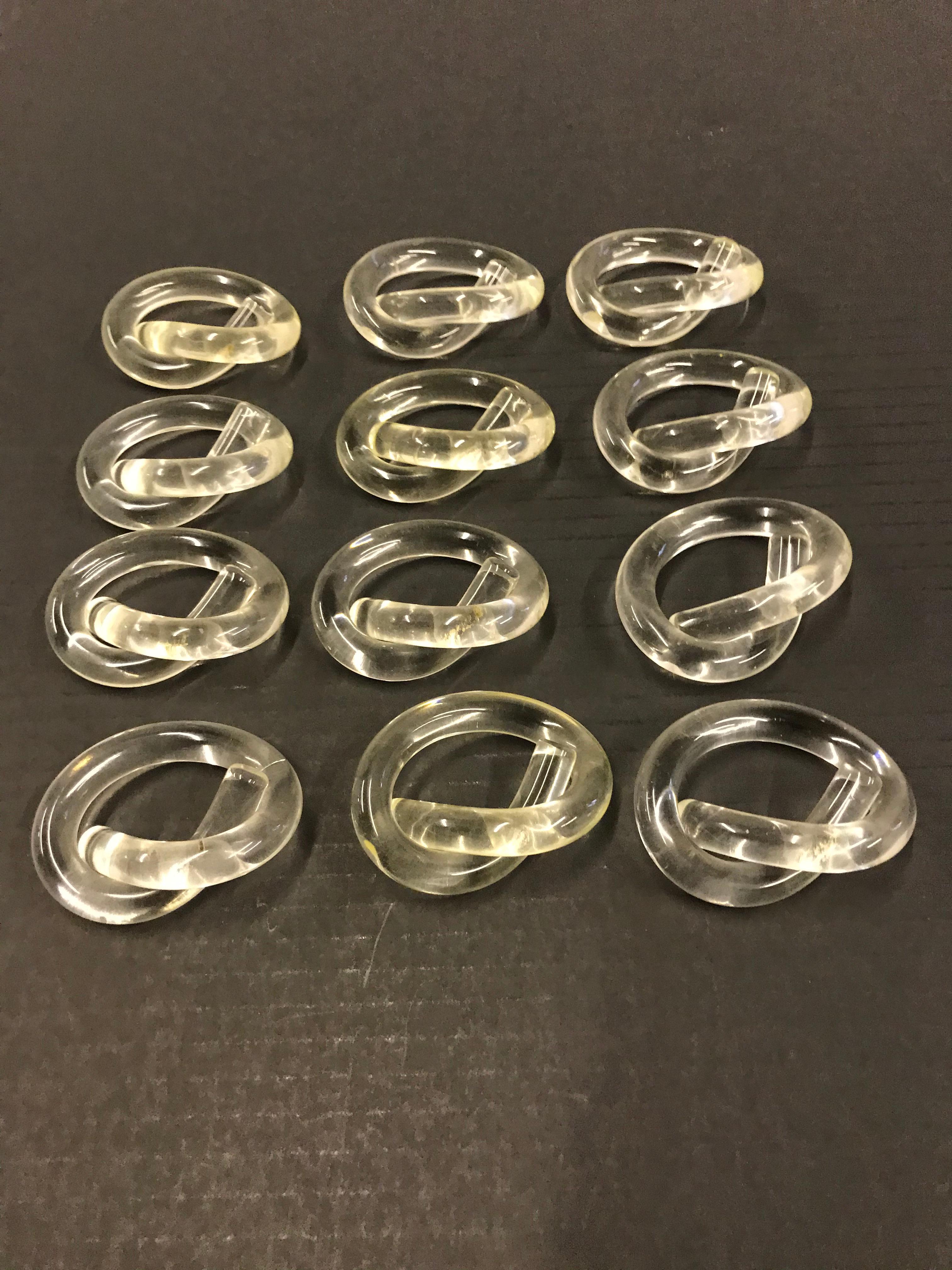 Dorothy Thorpe, a Mid-Century Modern icon and prolific artist, designed mostly for the table and here are 12 of her Lucite Napkin rings in the Pretzel form with a Lucite holder.
Measurements: Napkin rings 2 7/8 inches x 1 1/4 inches. Holder: Base 3
