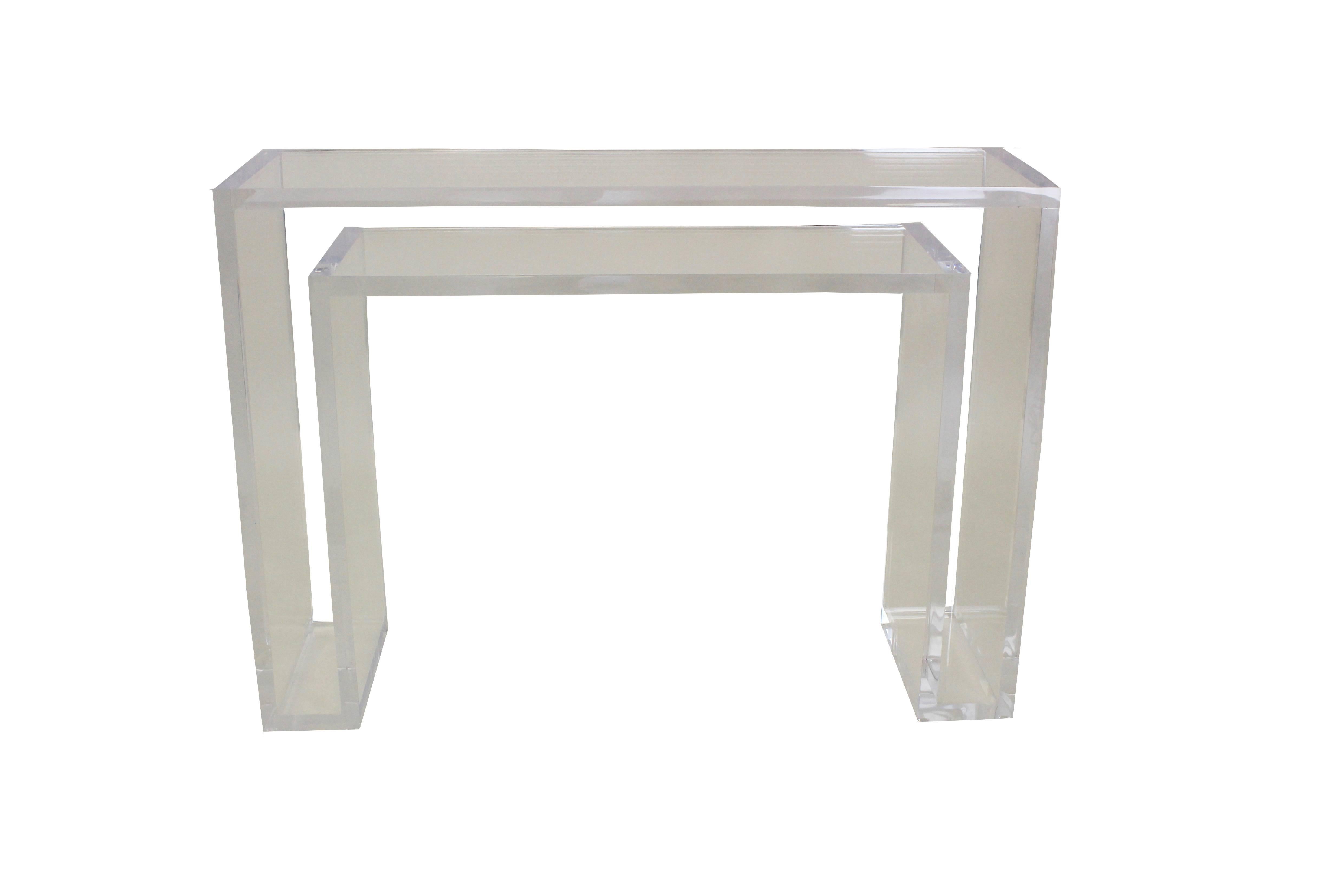 This modern console table is hand built with clear Lucite to blend seamlessly into any space. The table features a top and bottom shelf for added decoration opportunities. 

Built to order. Made in the USA.