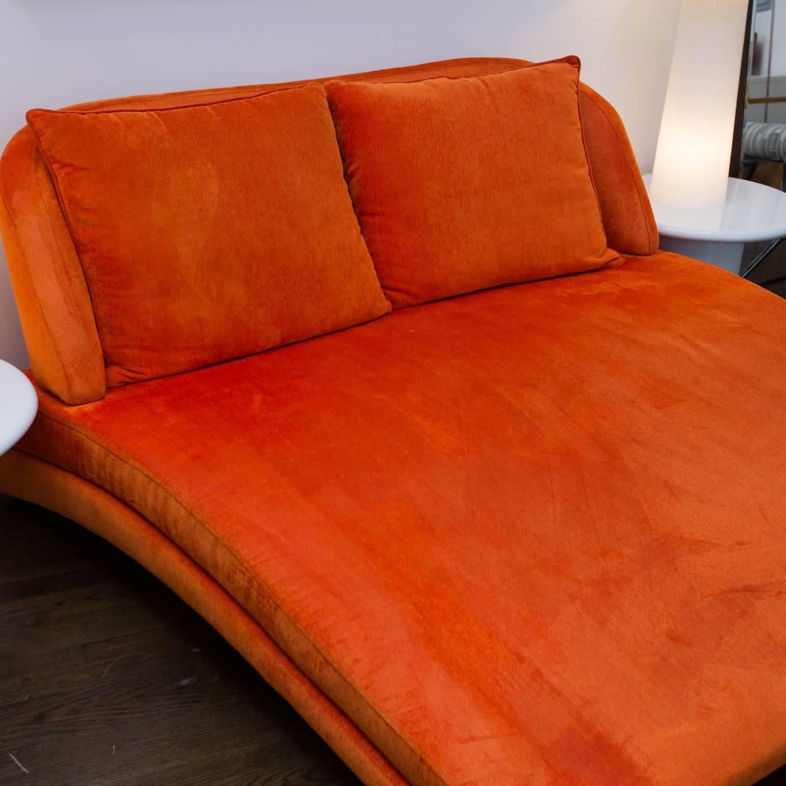 You will most likely never see another chaise quite like this one. It firs two comfortably and is finished in a durable orange cotton linen that is removable for dry cleaning.