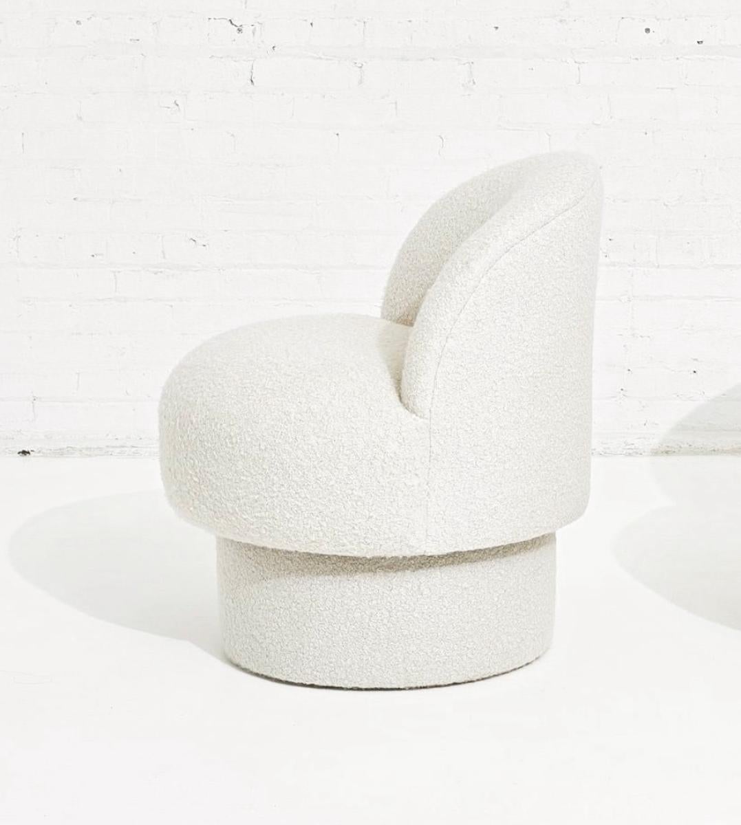 Swivel pouf upholstered in white Italian merino wool/poly blend performance boucle. COM upholstery option available as well.