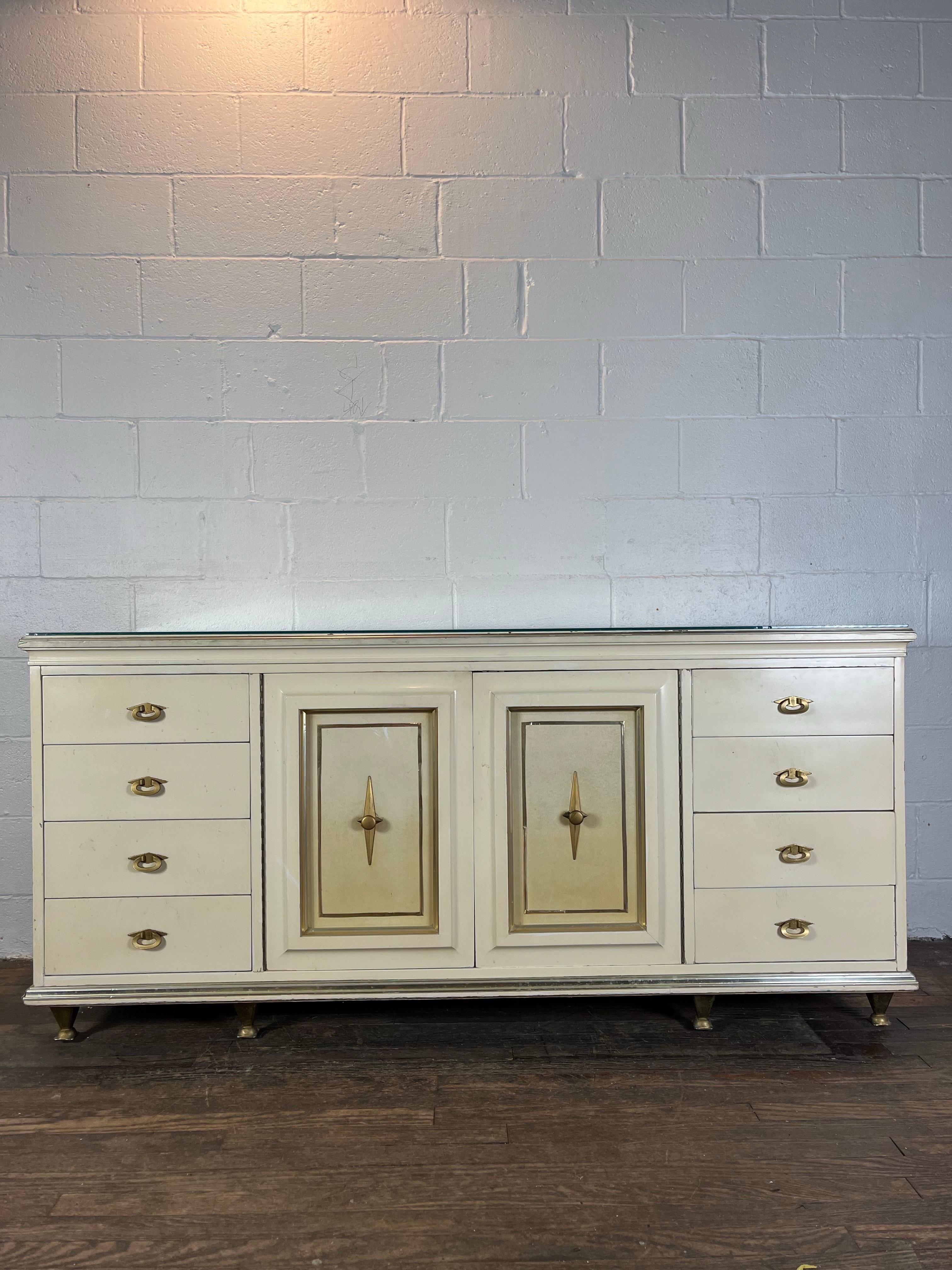 Stunning timeless design by American of Martinsville after Renzo Rutili. Long 11 drawer dresser with ample storage. Hardwood case accented with brass trim and hardware with leather inserts. Solid construction and very heavy.  Great investment piece. 