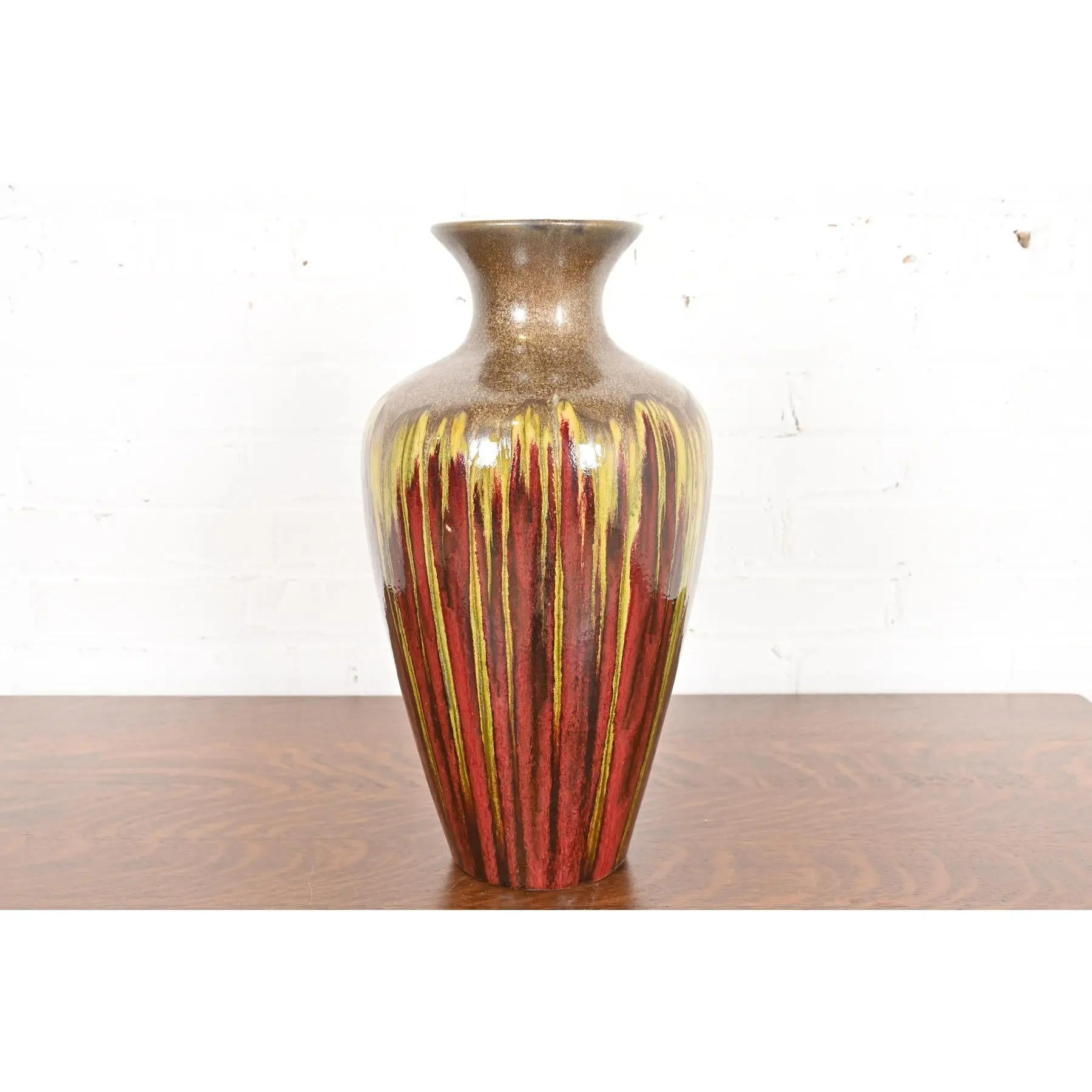 A gorgeous Modern drip glazed large urn form ceramic art pottery vase 

In the manner of Rookwood Pottery

Circa Late 20th Century

Glazed ceramic combining red, yellow, and gold tones.

Measures: 9.25