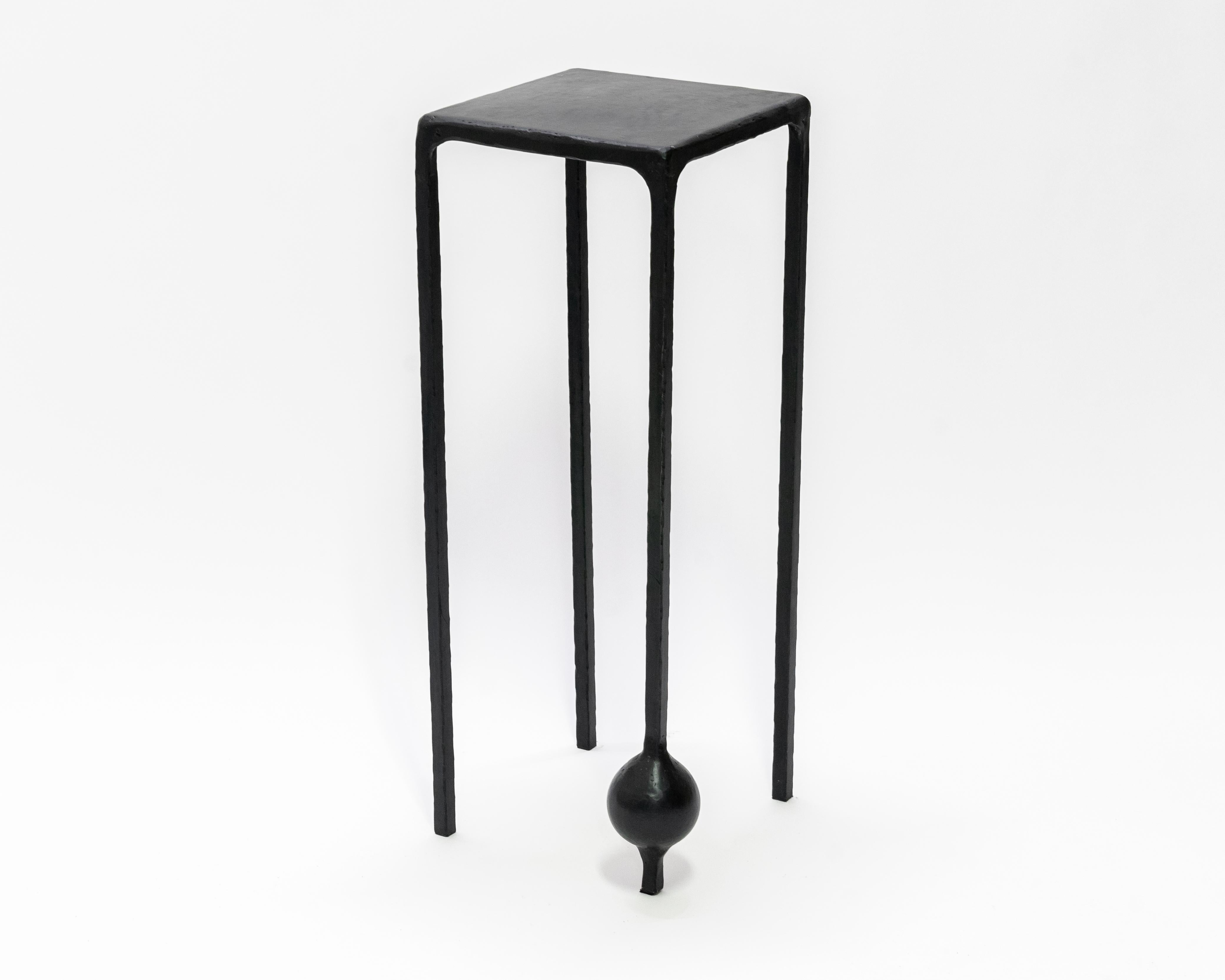 TABLE NO. 2 - Pedestal 
J.M. Szymanski
d. 2019

This geometric, solid, steel structure is supported by a cast-sphere base. The refined simplicity of this design speaks volumes, and adds depth and intrigue to any space. 

Custom sizes available. Made