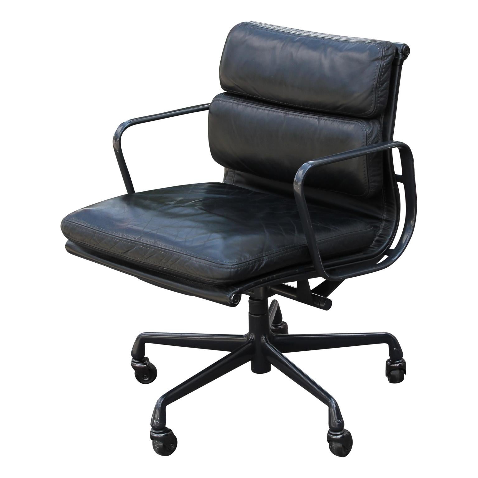Modern black leather and black aluminum soft padded office chair. The chair swivels and is on wheels. It was designed by Eames for Herman Miller.