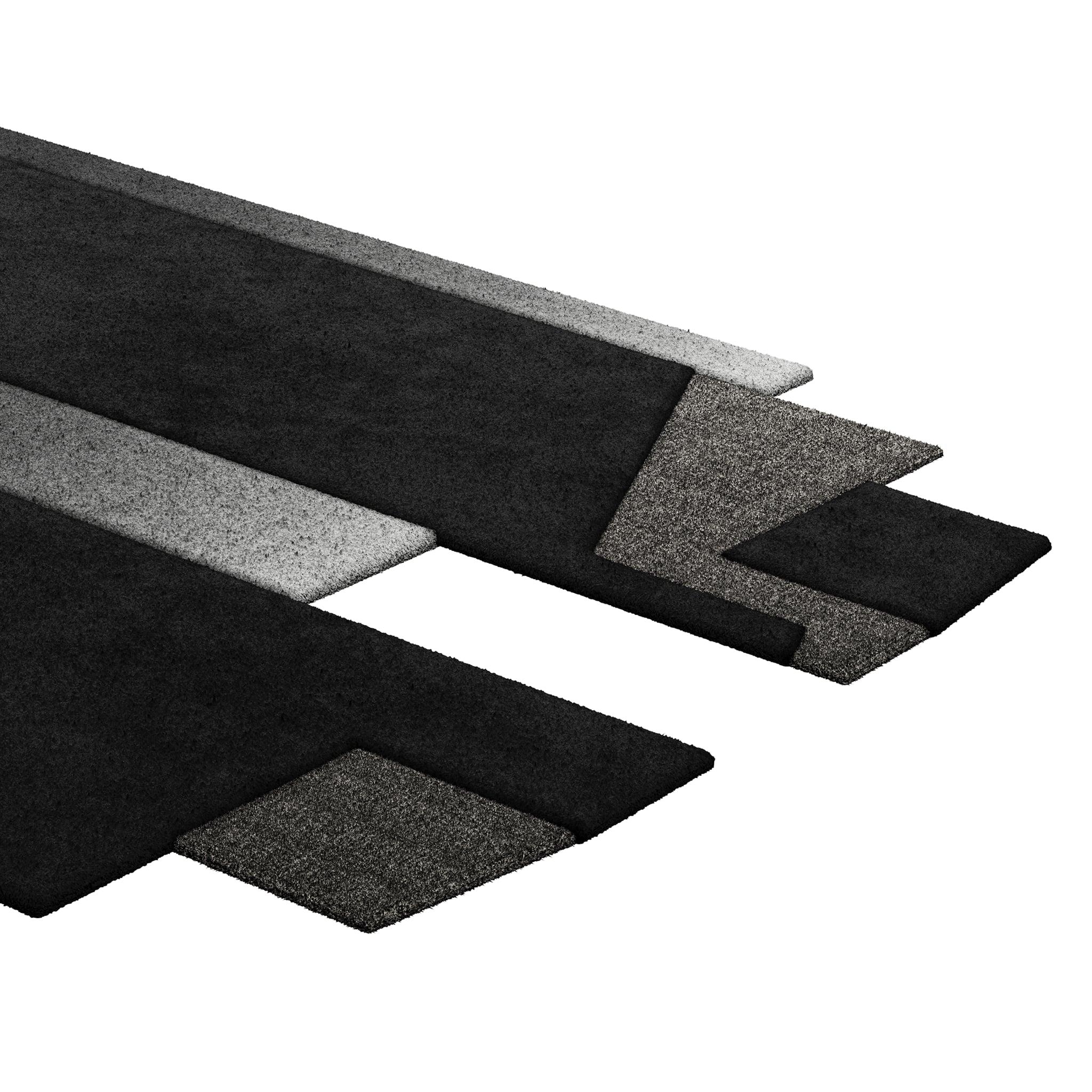 Tapis Retro #004 is a retro rug with an irregular shape and monochromatic hues. Inspired by architectural lines, this geometric rug makes a statement in any living space.

Using a 3D-tufted technique that combines cut and loop pile, the retro rug