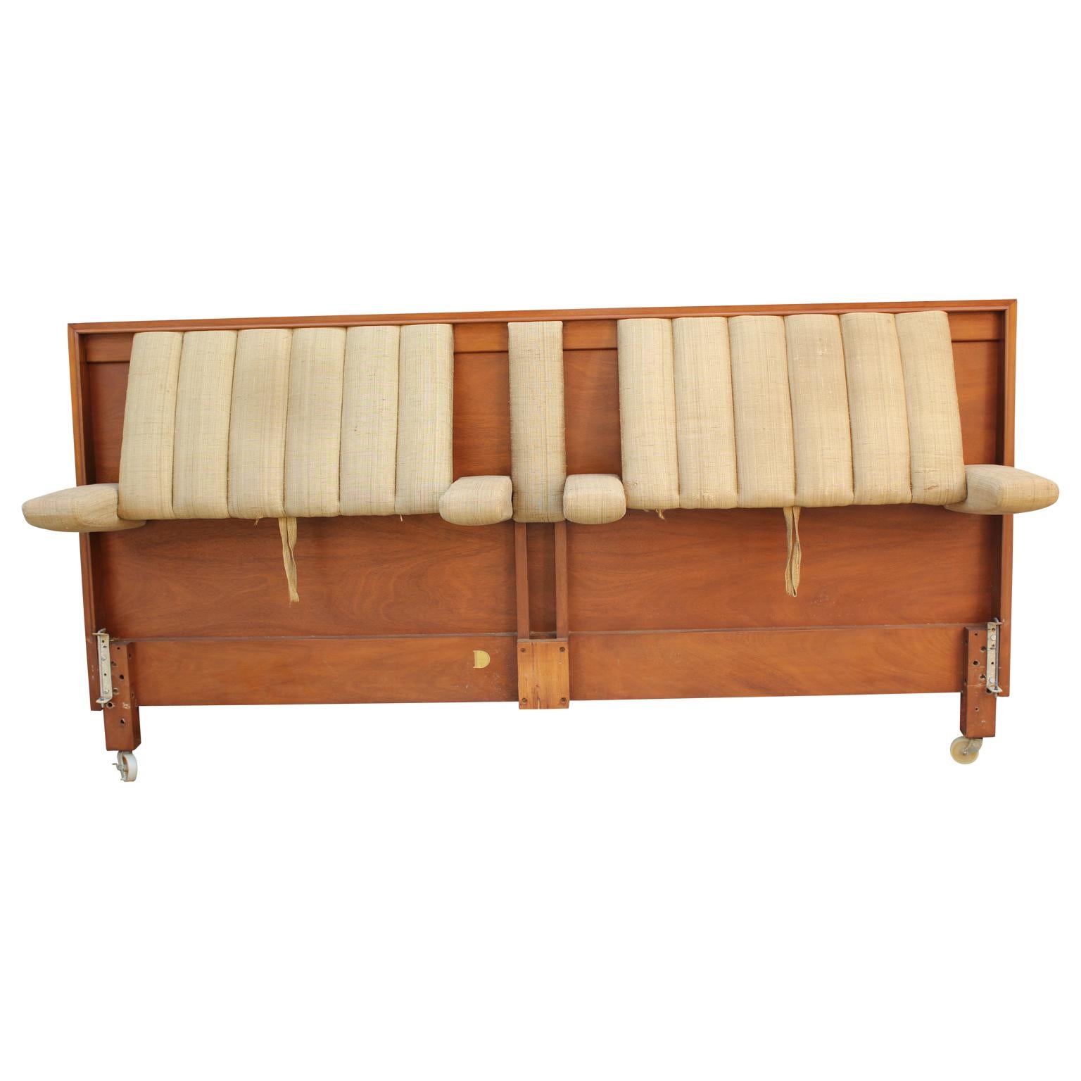 Unique King sized walnut headboard designed by Edward Wormely for Dunbar. This headboard features two pulls that tilts the headboard back and drops down arm rests for optimal comfort while sitting up in bed. Wonderful and rare piece! Model