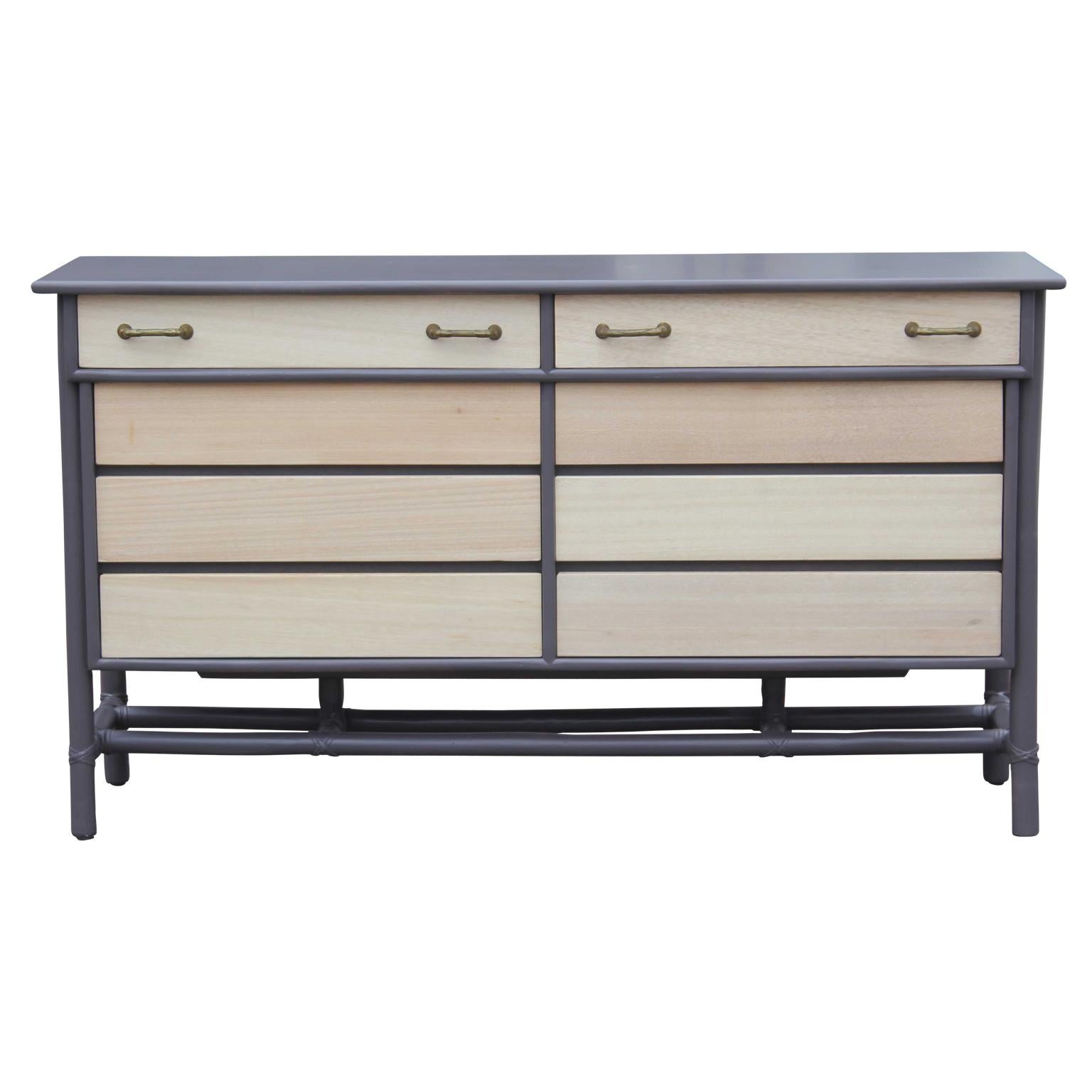 Lovely refinished eight-drawer grey and natural finish dresser with brass handles and faux bamboo flare by McGuire.