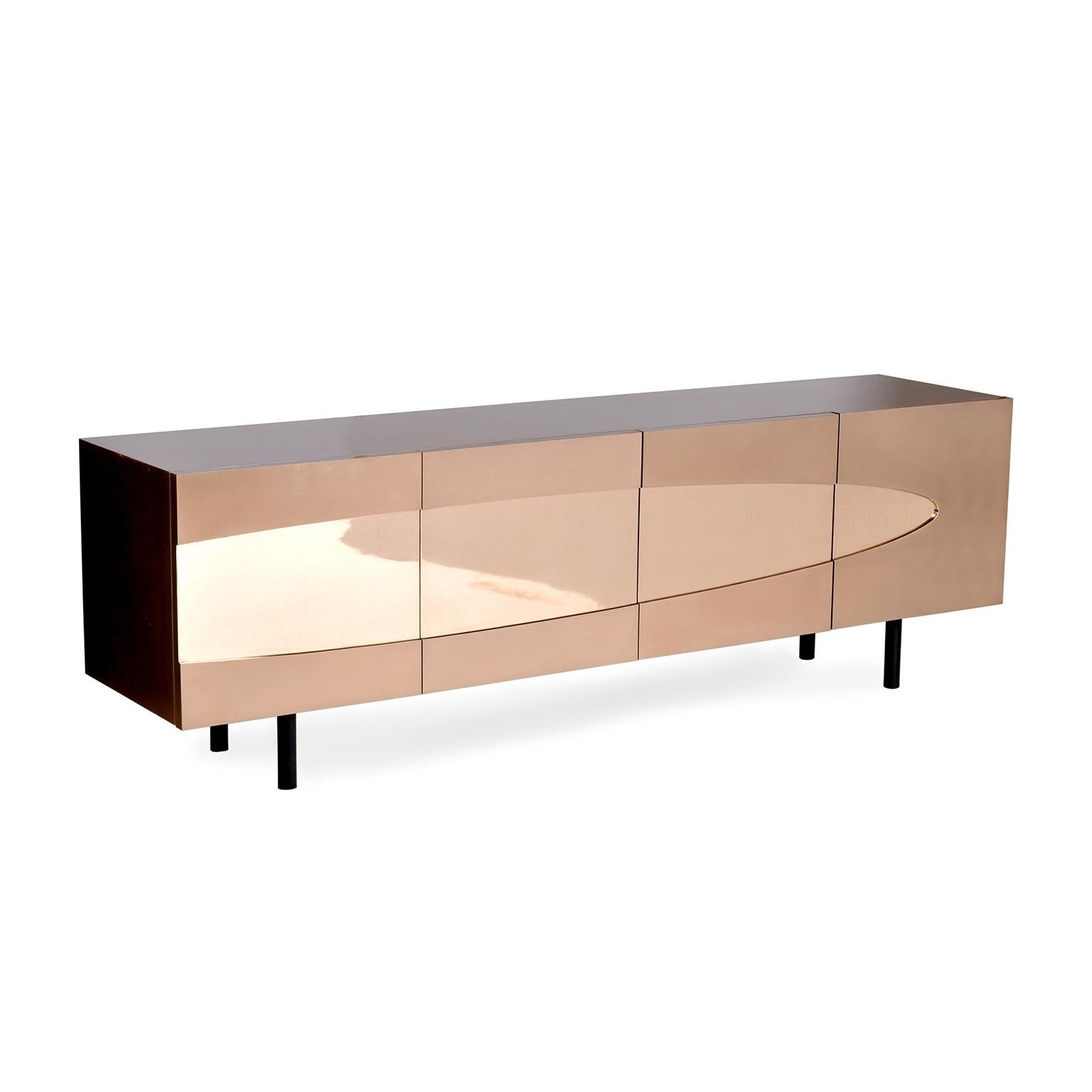 Our Ellipse series is all about the effect positive and negative shapes have on our perception of form. The Ellipse Sideboard is clad entirely in Bronze with a polished bronze center ellipse and a satin bronze case and doors. The interior is a