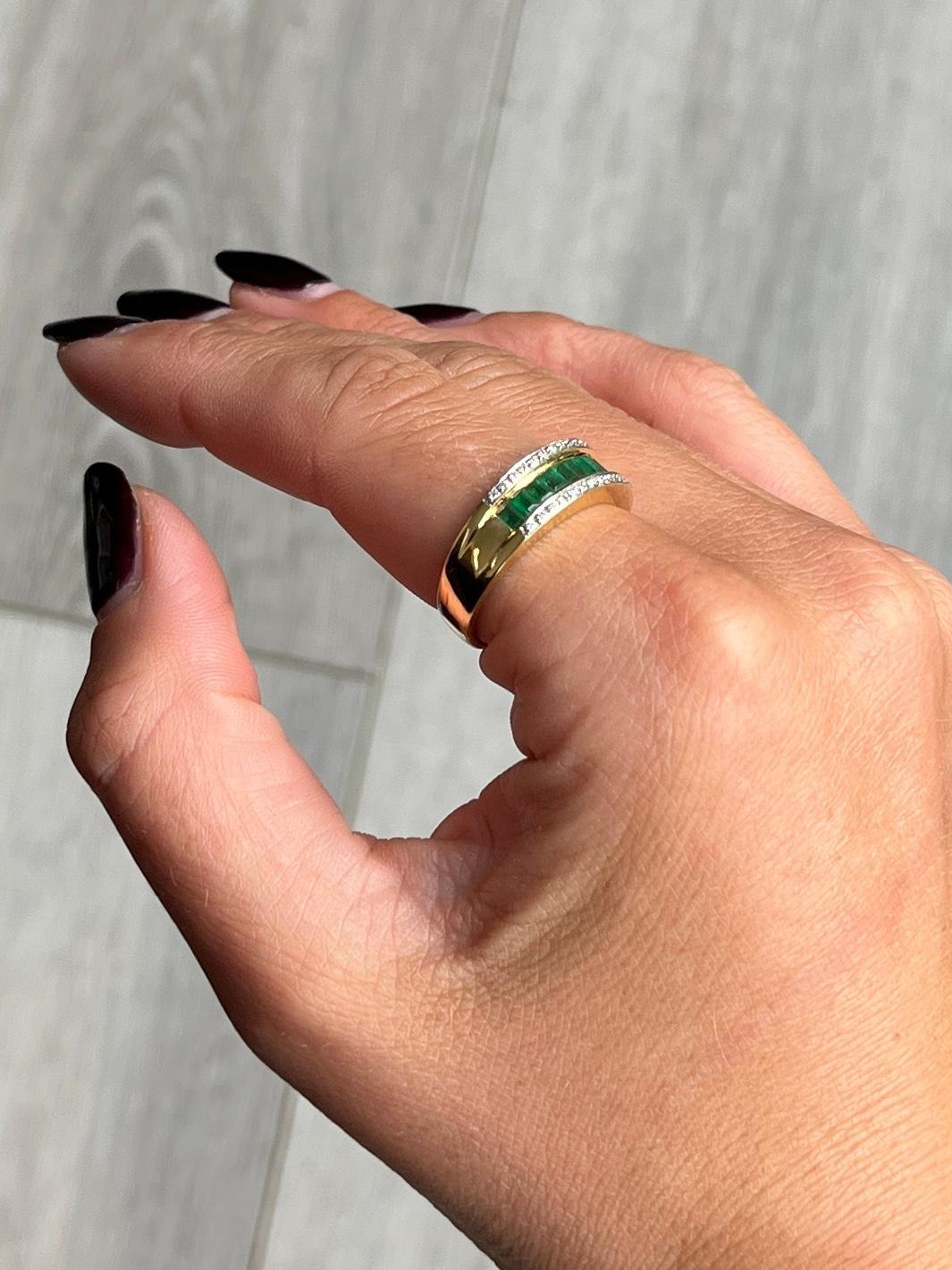 The emerald cut emeralds in this ring are beautiful and bright and total 48pts. Above and below the row of bright emeralds there are diamond. Each diamond measures 1pt each. The ring is modelled in 18carat gold.

Ring Size: Q or 8
Band Width: