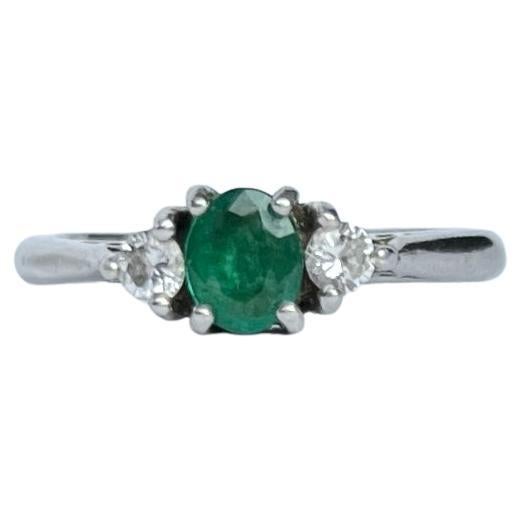 Modern Emerald and Diamond Platinum Three-Stone Ring