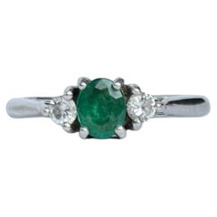 Retro Modern Emerald and Diamond Platinum Three-Stone Ring