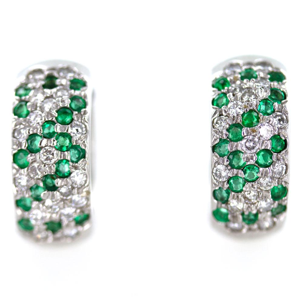 Brilliant diamond and emerald huggie earrings. These modern style huggie features 38 round brilliant cut diamonds (.75 carat total weight) and 38 round cut emeralds. Measuring 8mm in width and 18mm in length and diameter, the huggies are crafted in