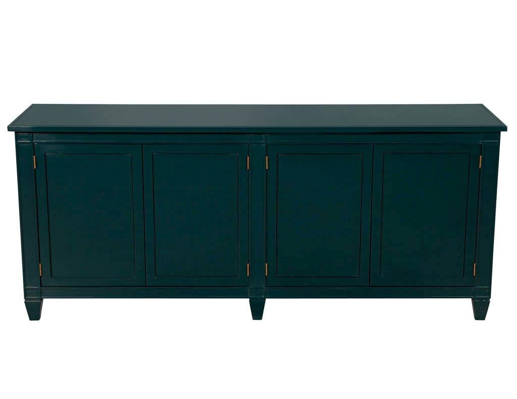 Modern emerald hand polished sideboard buffet. Featuring stunning hand polished emerald lacquer finish with brass finished hinges for a beautiful contrasting look. Interior features ample storage with 2 oversized drawers felted in black with 2