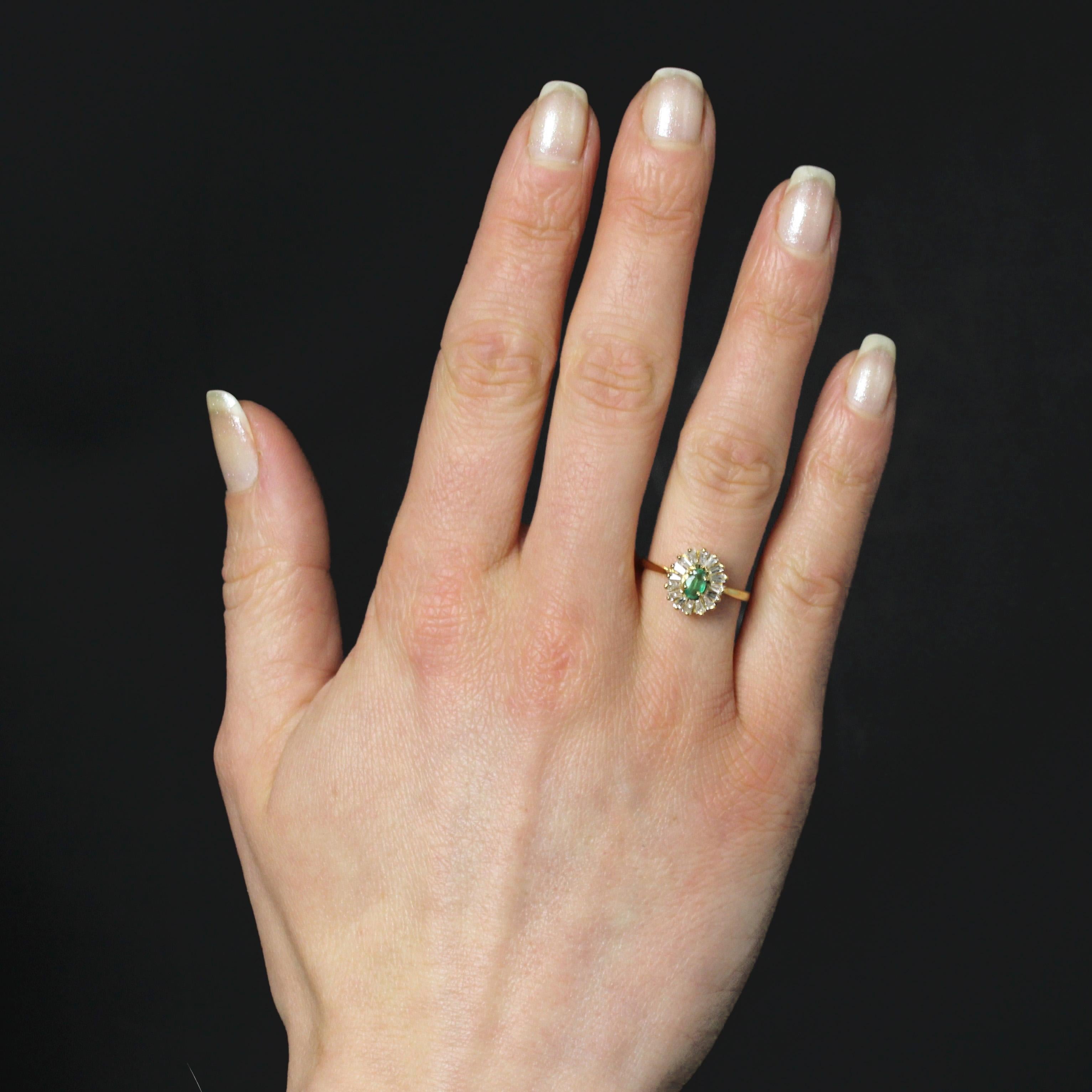 Ring in 18 karat yellow gold, weevil hallmark.
The oval setting of this emerald occasion ring is adorned with gold wires and holds an oval emerald in a trapeze-cut diamond surround at the top with 4 claws.
Height : 11 mm approximately, width : 9.5