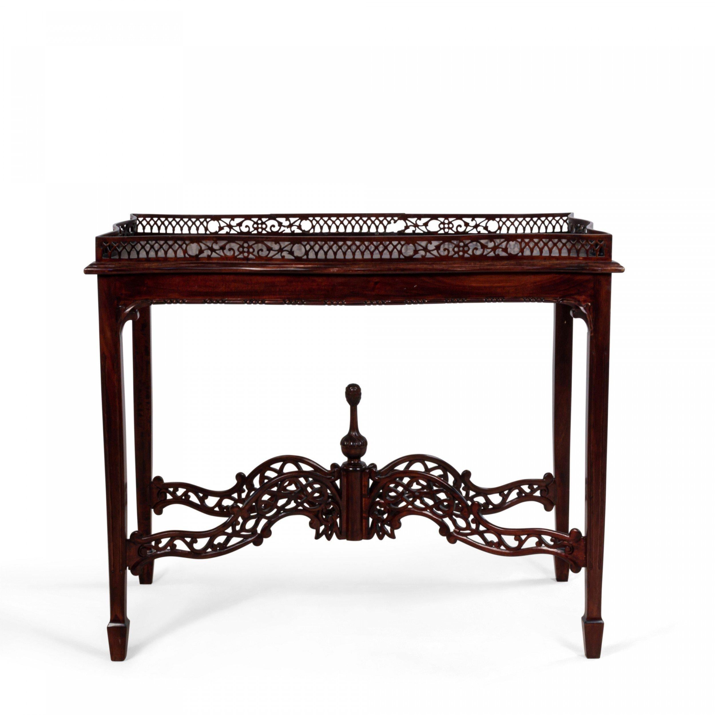 20th century English Chinese Chippendale style mahogany table with carved gallery, spade feet, and stretcher base with decorative carved finial.