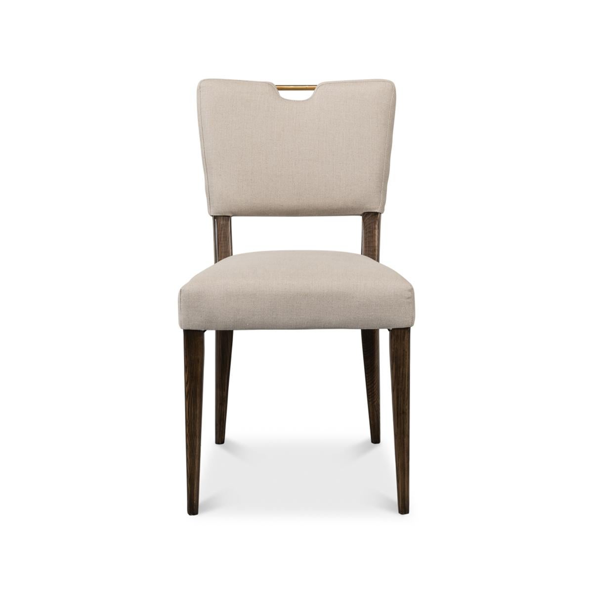 Modern English dining chair, with graceful lines and a full curved back to accentuate comfort, a linen cover speaks to soft tactile luxury. From a board meeting to dinner for twelve, these are the statement piece every great host