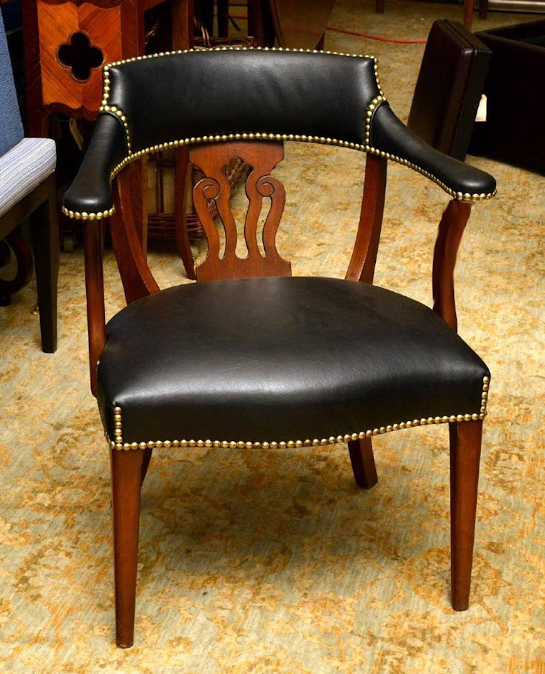 Modern English mahogany and leather captains chair, of typical form with subtle details, custom calfskin leather upholstery.
Provenance: Acquired from Jacques Grange.