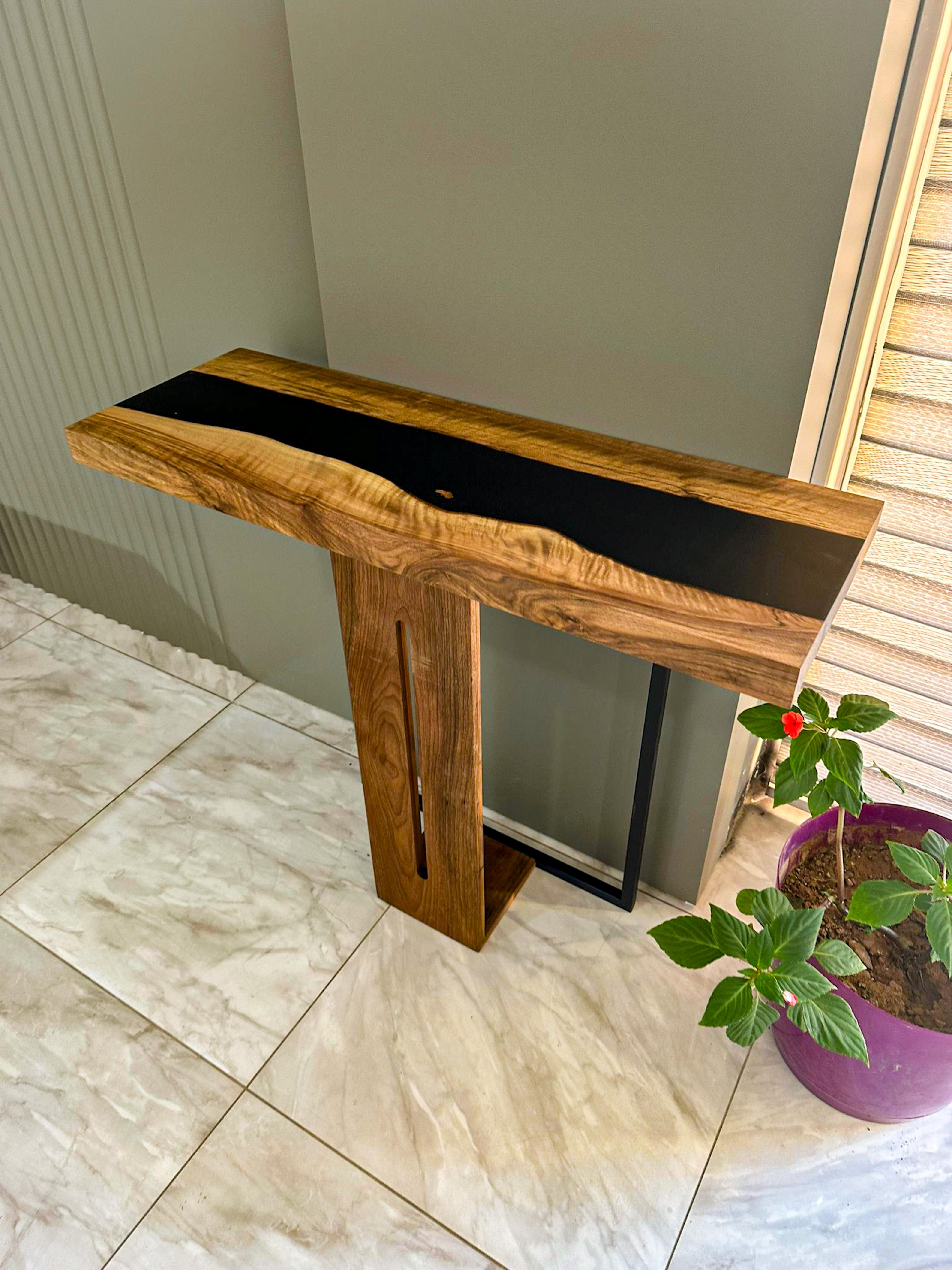 Tavolo Consolle Waterfall Hackberry in legno massiccio epossidico

Ti presentiamo il nostro tavolo consolle a cascata in resina epossidica, un vero esempio di artigianalità ed eleganza. Questo eccezionale mobile è stato progettato per essere più di