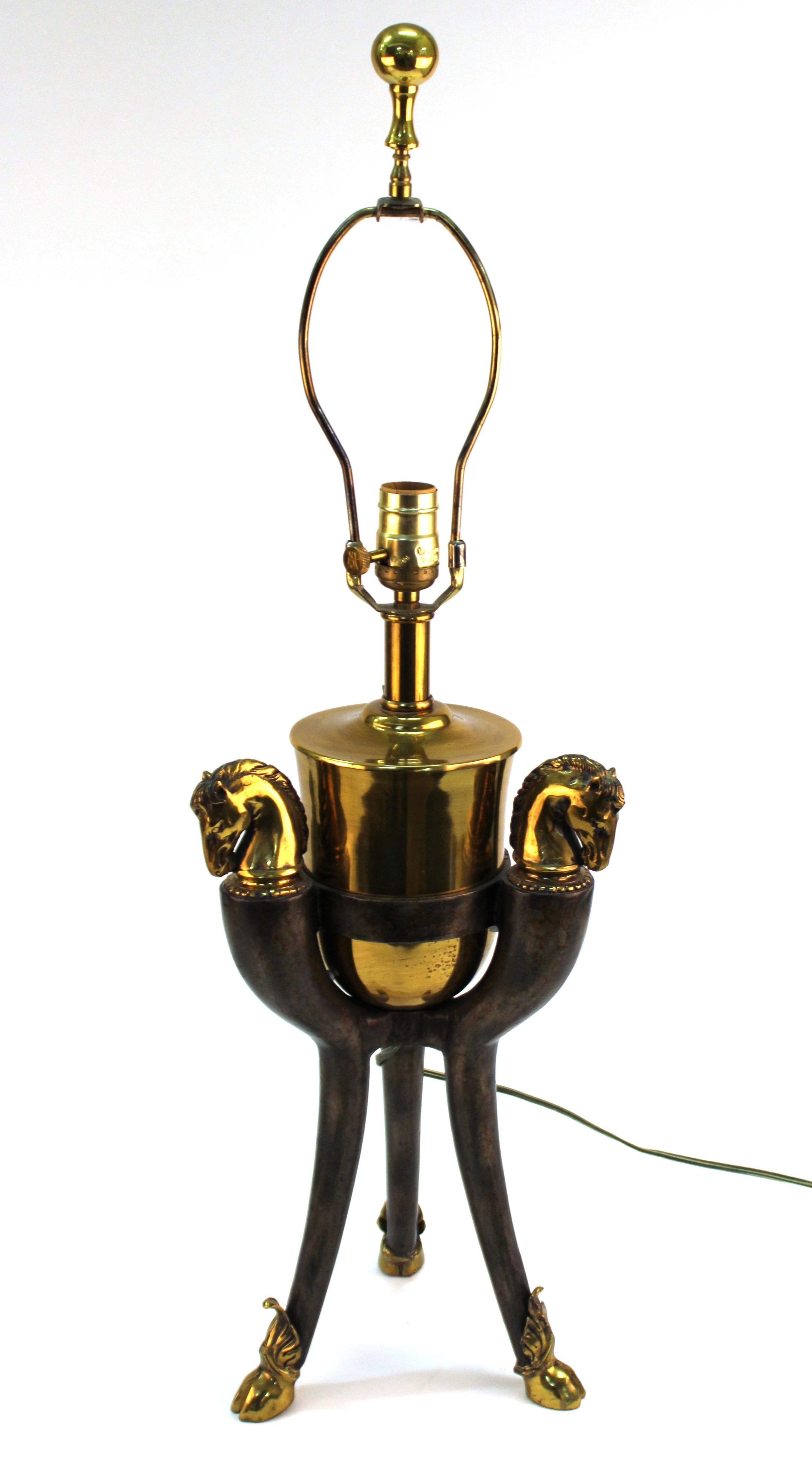 Modern pair of equestrian themed table lamps with horse heads and tripod bases with hoofed legs. The pair was likely made during the late 20th century and is in great vintage condition with some age-related wear to the bases.