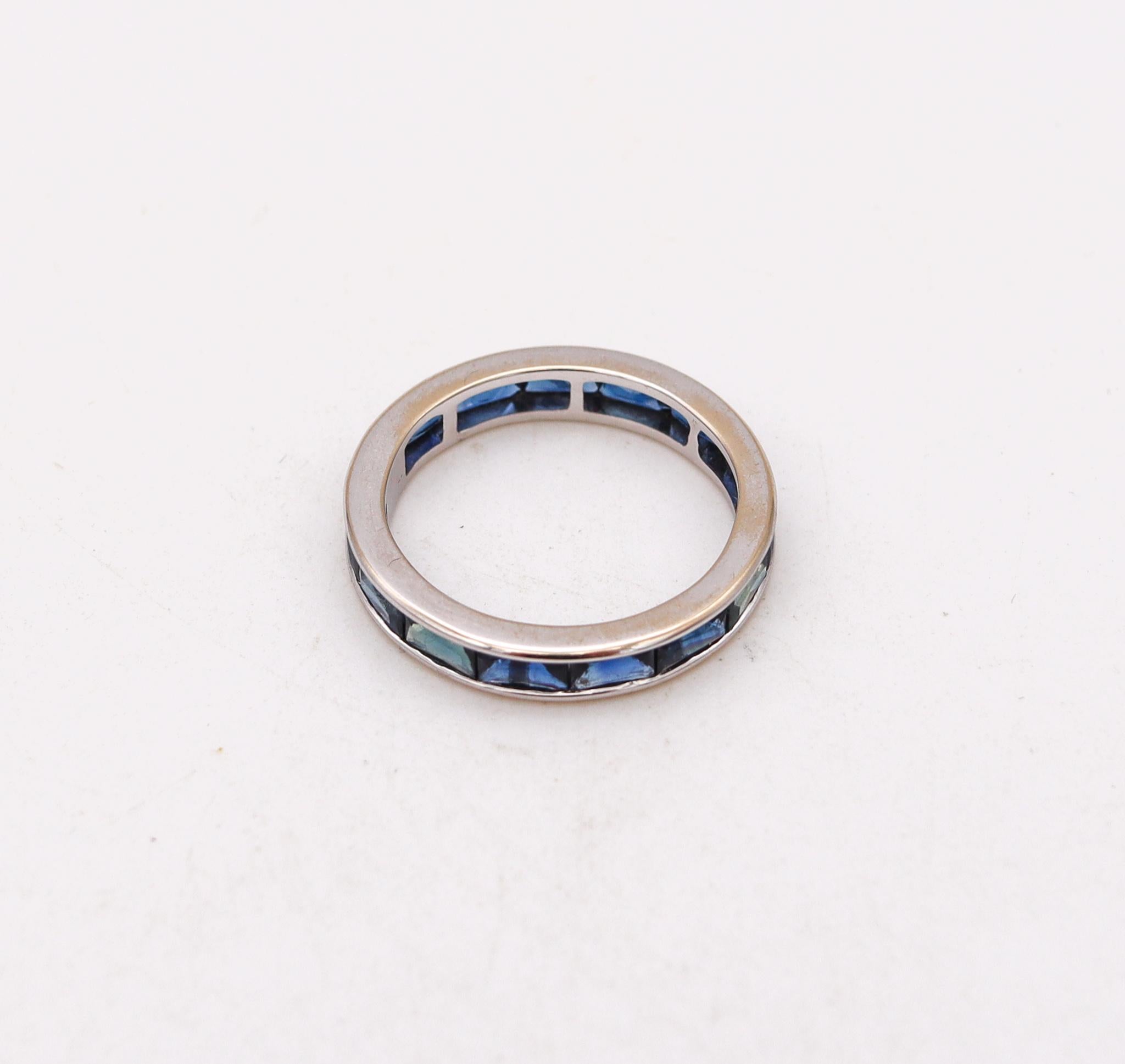 An eternity band with Sapphires baguettes.

Classic contemporary eternity ring, crafted in solid white gold of 18 karats, with high polished finish. It is mount in a channel-set, with 14 French cut baguettes of natural blue sapphires with a combined