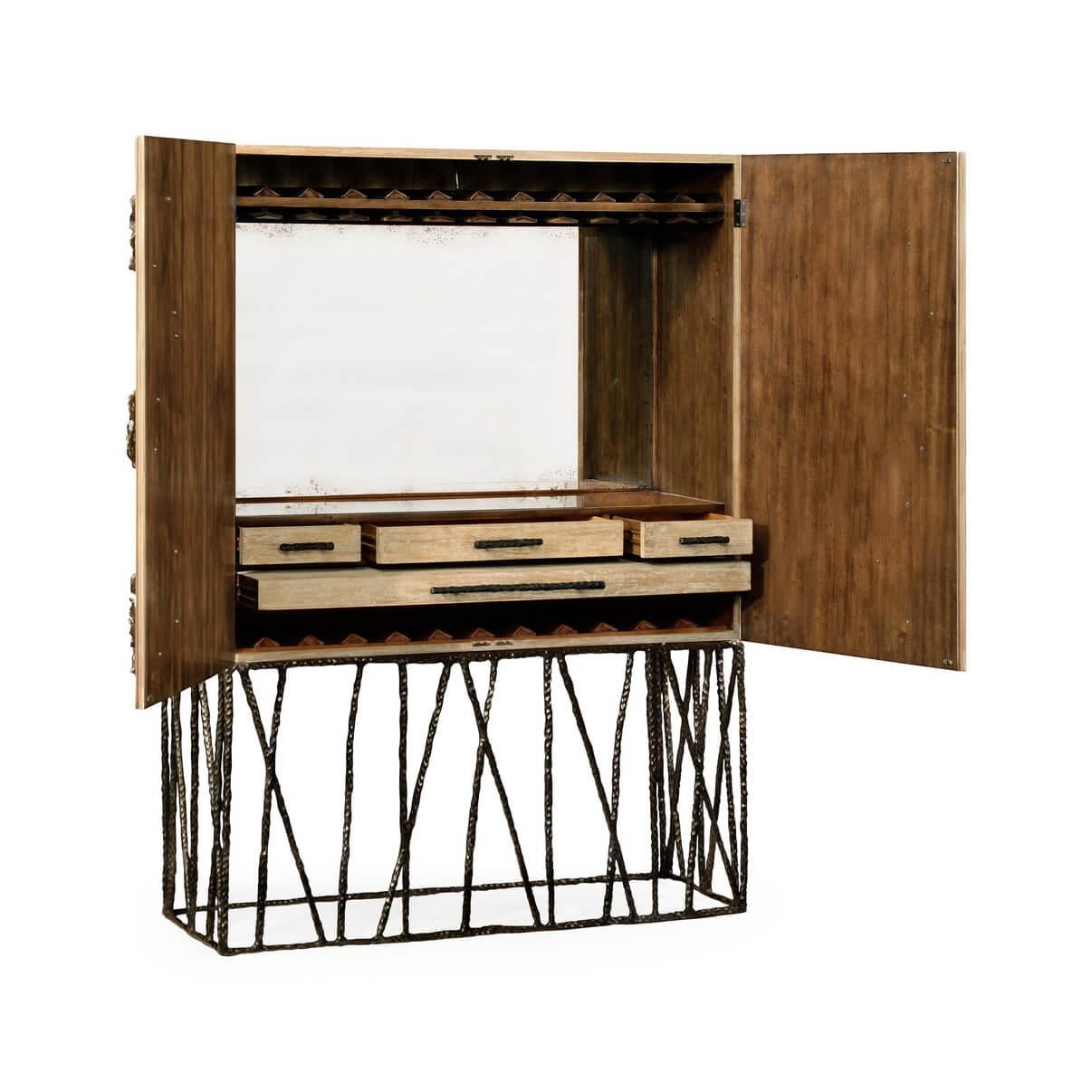 Spectacular limed wood and walnut lined drinks cabinet with hammered bronzed openwork base and abstract leaf details to the doors. Inspired by European luxury furniture of the 1940s.

Dimensions: 47 3/4