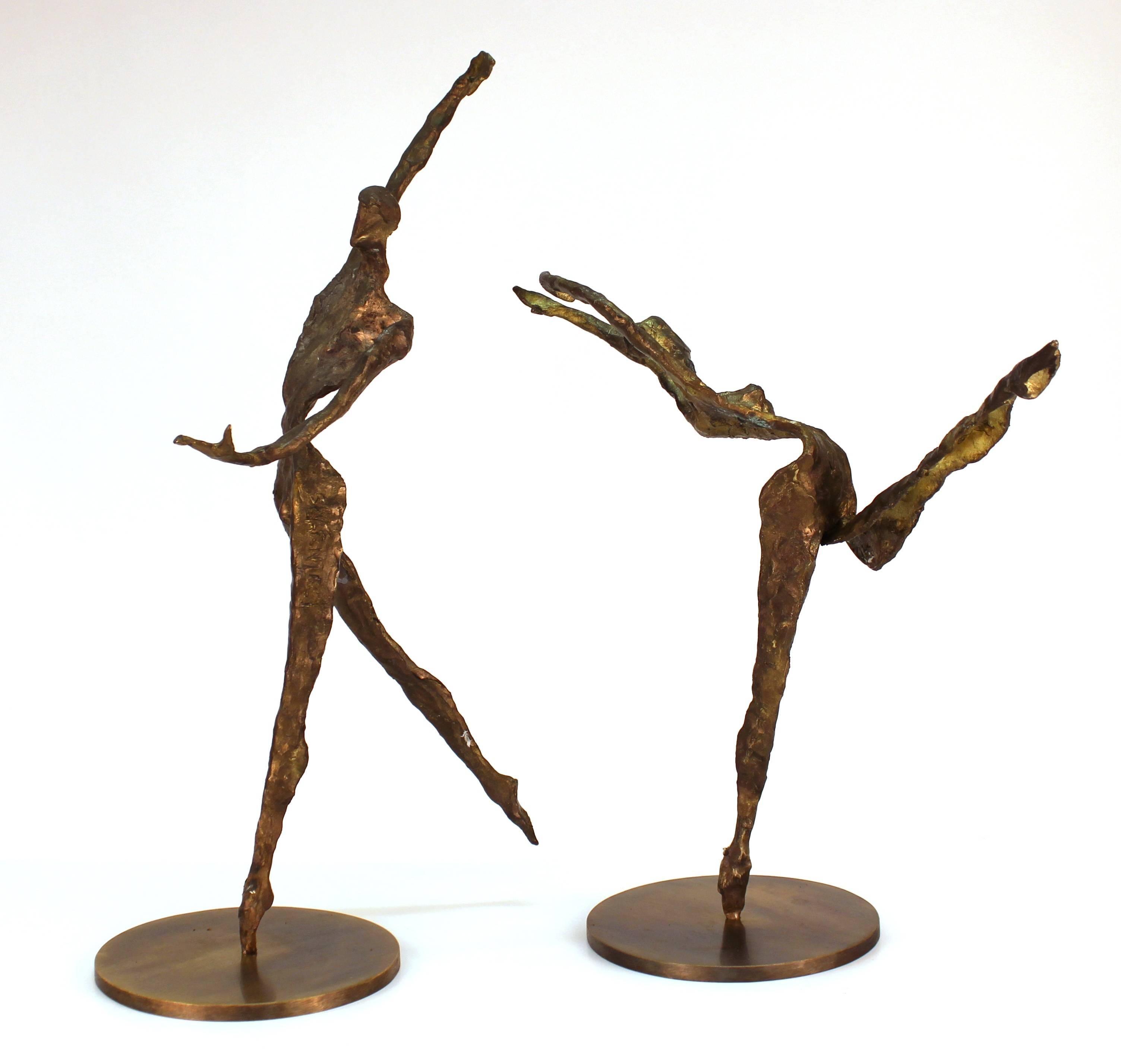 A modern pair of bronze sculptures of a duo of dancers in movement, sculpted in an Expressionist figurative manner and fixed atop circular bronze bases. There is a signature on the upper leg of the female dancer. The pair is in great vintage