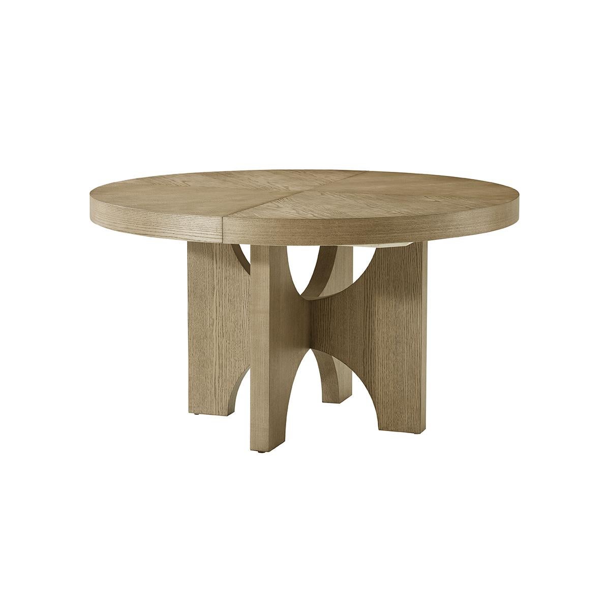 Modern Ash Dining Table, crafted from premium-figured cathedral ash in the Dune finish, this dining table boasts a rich texture and a sleek, light finish that adds a touch of elegance to any dining room. The closed round shape of the table invites