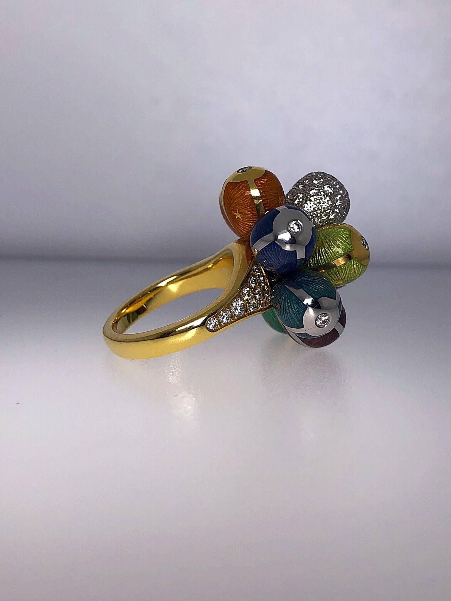 This stunning Modern Victor Mayer Faberge Ring is composed of a cluster of 9 Multi-Colored guilloché  enamel eggs and one diamond egg, set in both 18 karat white and yellow gold. Each enamel egg is accented with one round brilliant diamond in the