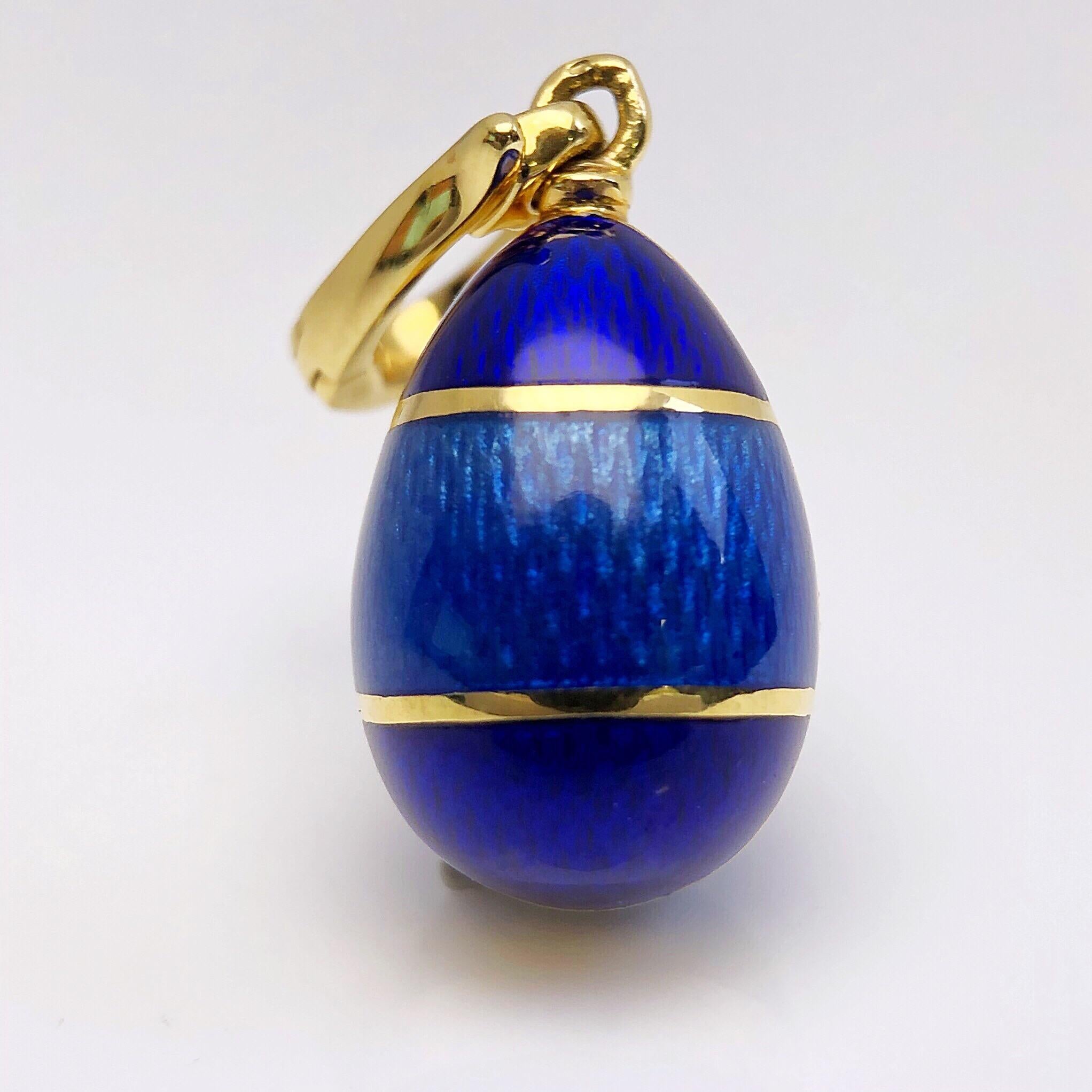 This modern 18 karat yellow gold and enamel egg was created by Victor Mayer. Crafted in the tradition of the original Imperial eggs, this pendant egg was designed to commemorate the new millennium. 
It features guilloche enamel in royal and medium