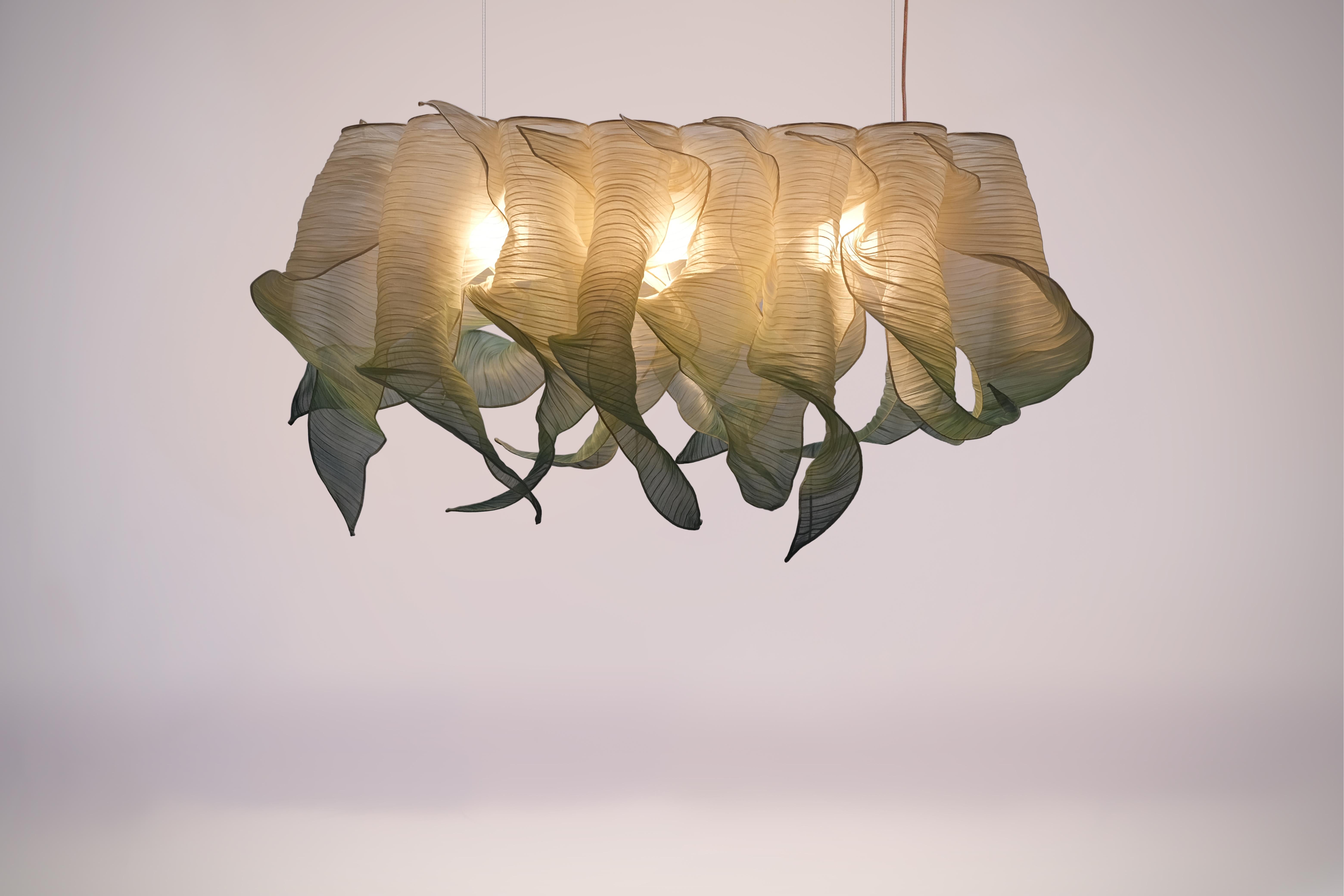 Providing soft light in an organic and unique design, the Nebula Lamp draws its inspiration from the interstellar clouds of dust and gas. Entirely handcrafted of Banaca (banana-abaca), a fiber from the Philippines woven by a community of weavers in