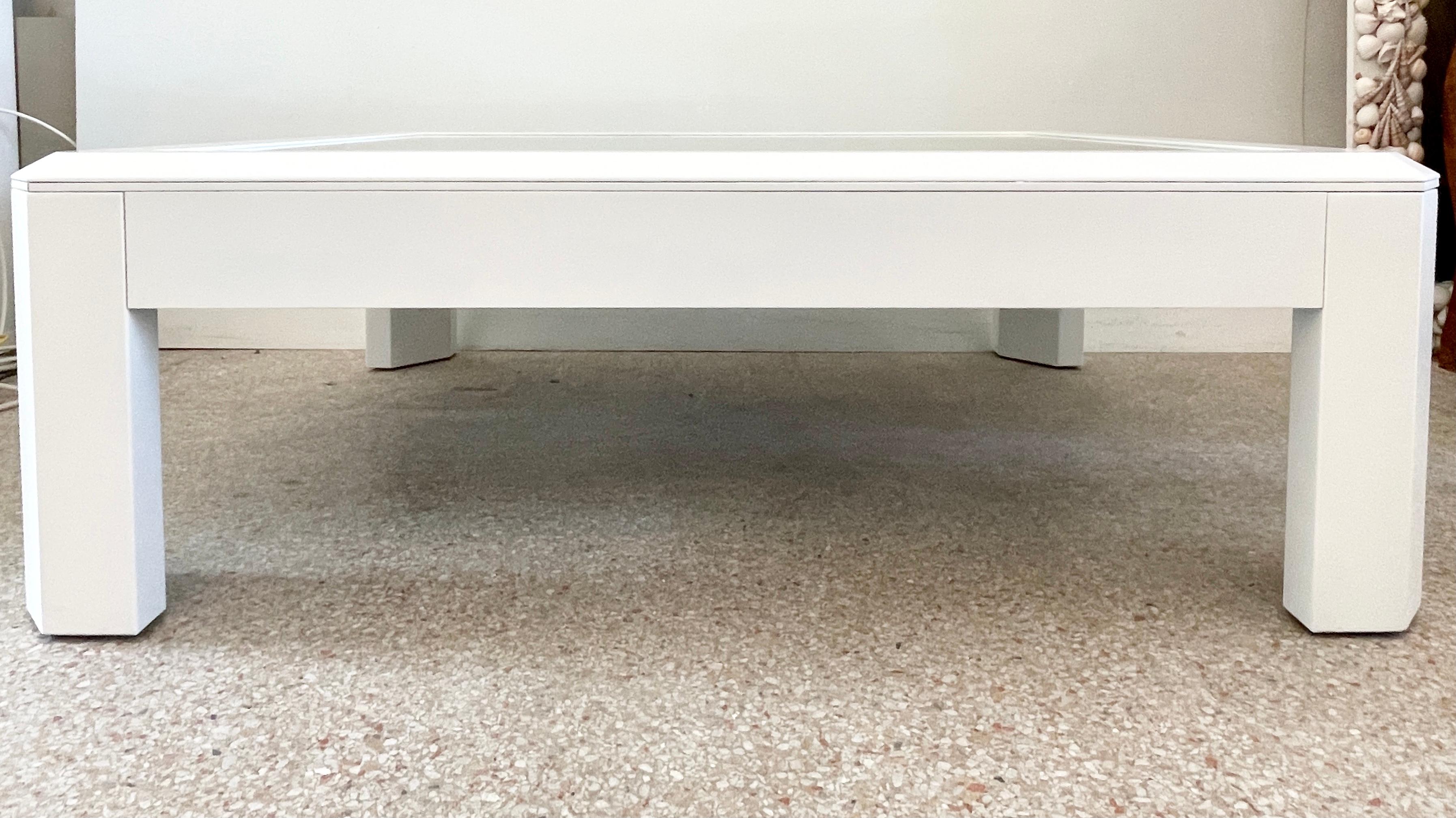 Fabulous modern faceted mirror top coffee table freshly lacquered in white. Mirror is new. Would make an amazing addition to your modern interiors.