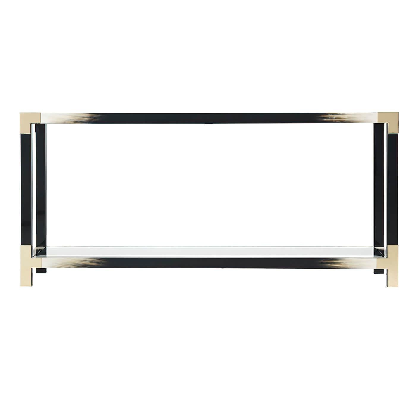 A Modern black lacquered and faux horn console table, the rectangular glass inset top with brass edged corners, on square legs joined by stretchers inset with a glass under tier.
Dimensions: 65