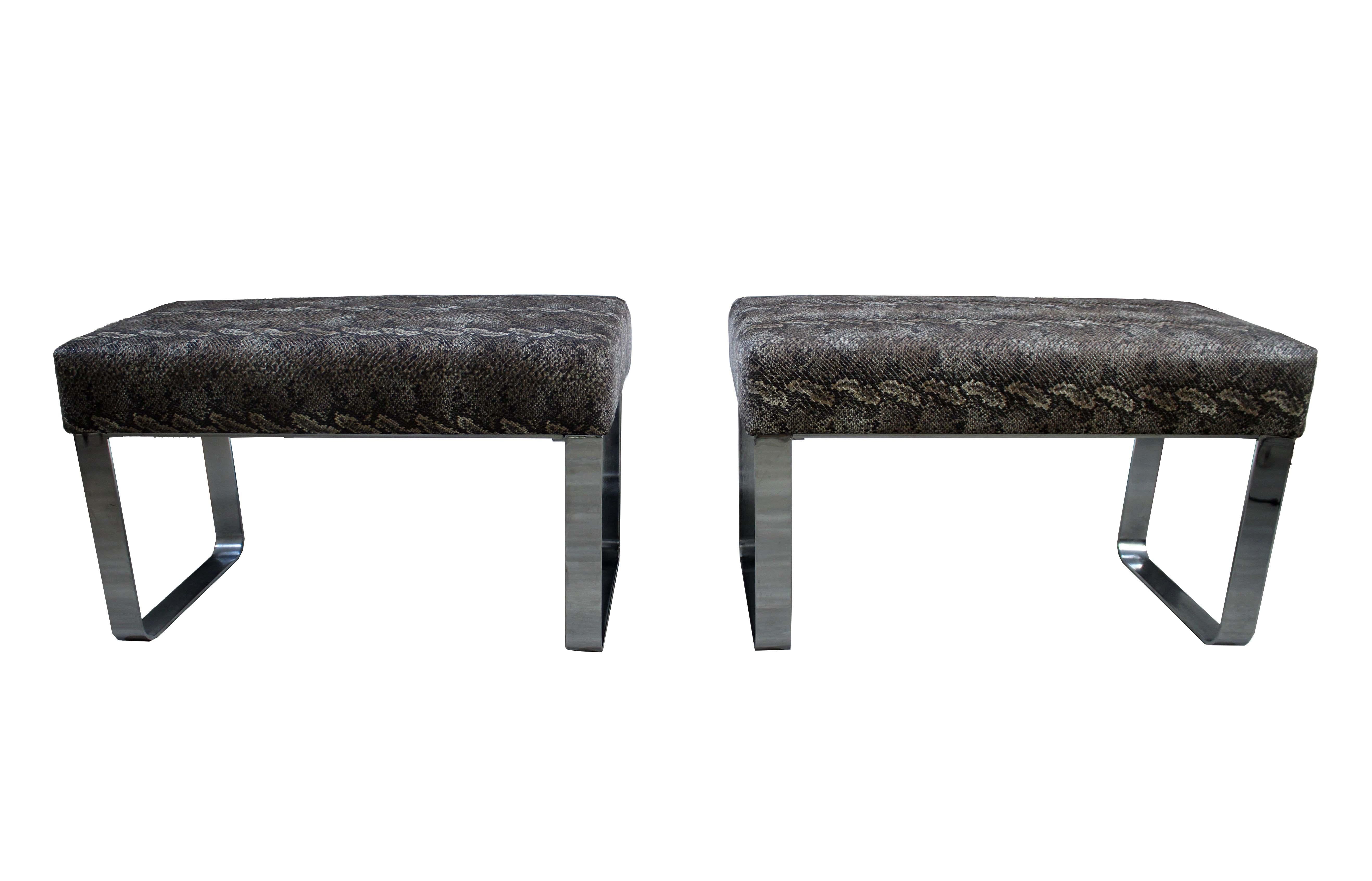This stunning faux python covered console table with two ottomans is sure to be a conversation piece in any room. The table is made of a durable construction with a faux python patterned fabric covering. The ottomans are made of a matching faux
