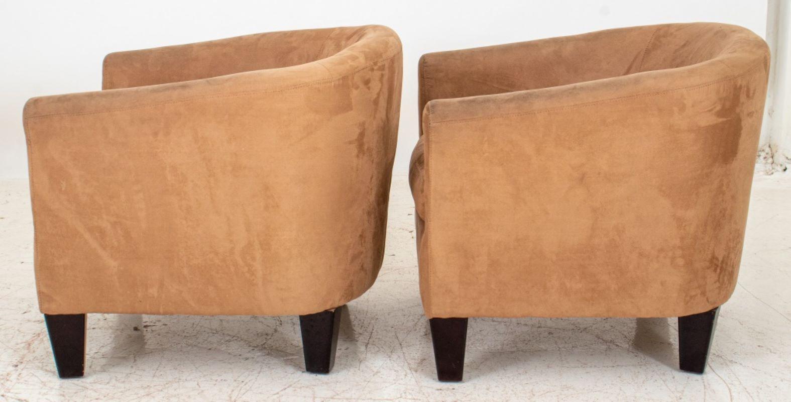 Modern fawn-colored ultrasuede covered tub chairs with drop in cushion on ebonized black tapering square feet. Measures: 27