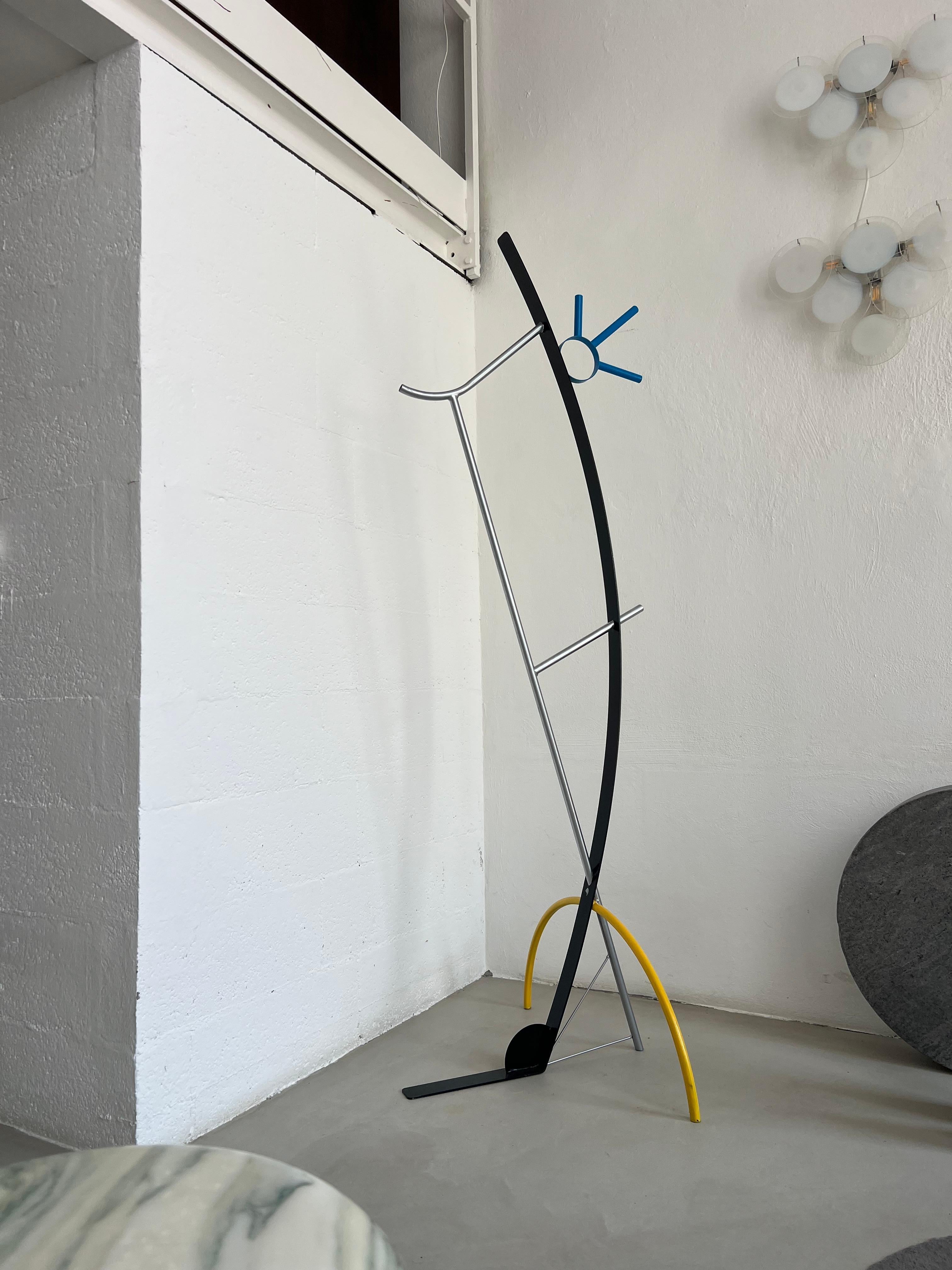 Abstract and figurative metal artwork,  slender metal sculpture that stands gracefully, capturing the essence of a human figure in minimalist form. The body is represented with just a few elegant lines, giving it a delicate appearance while