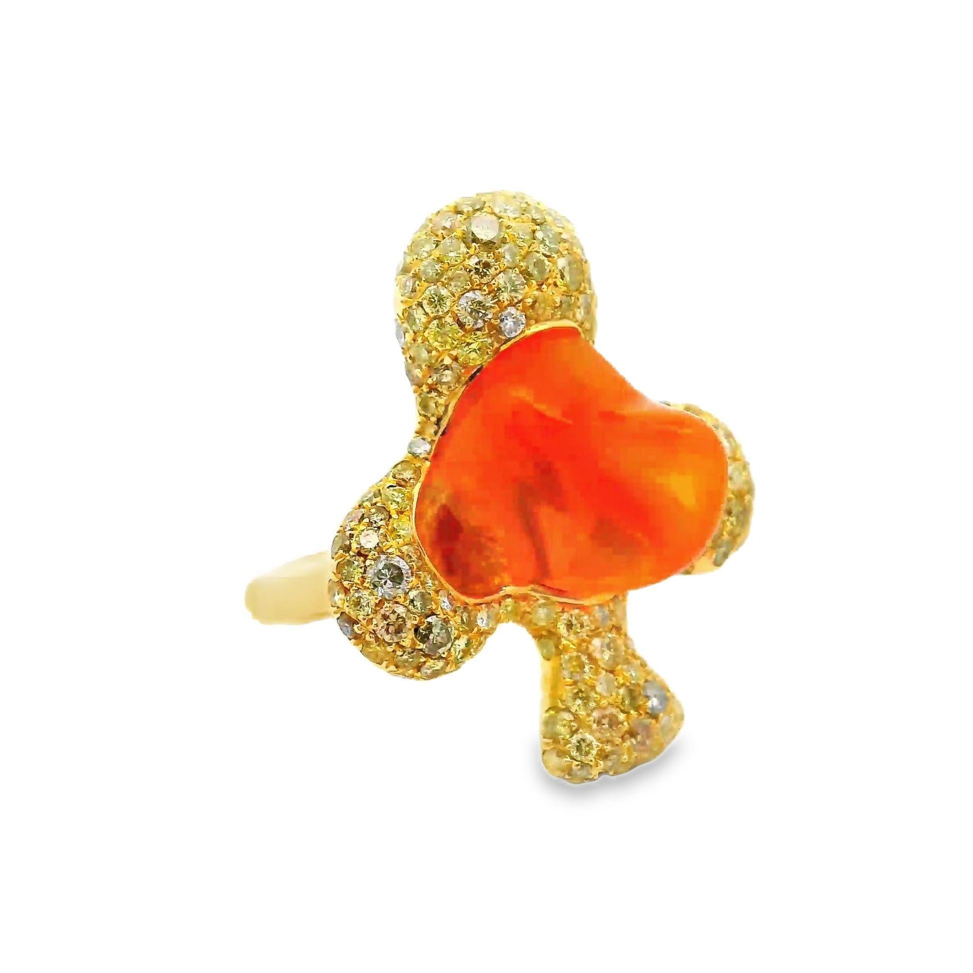 A sweet and stylish ring featuring a 6.37 carat smooth freeform Mexican fire opal. It has a rich jelly orange color and is complemented by 2.48 carats of fancy-colored diamonds. The ring is designed in the shape of an Ace giving it a modern
