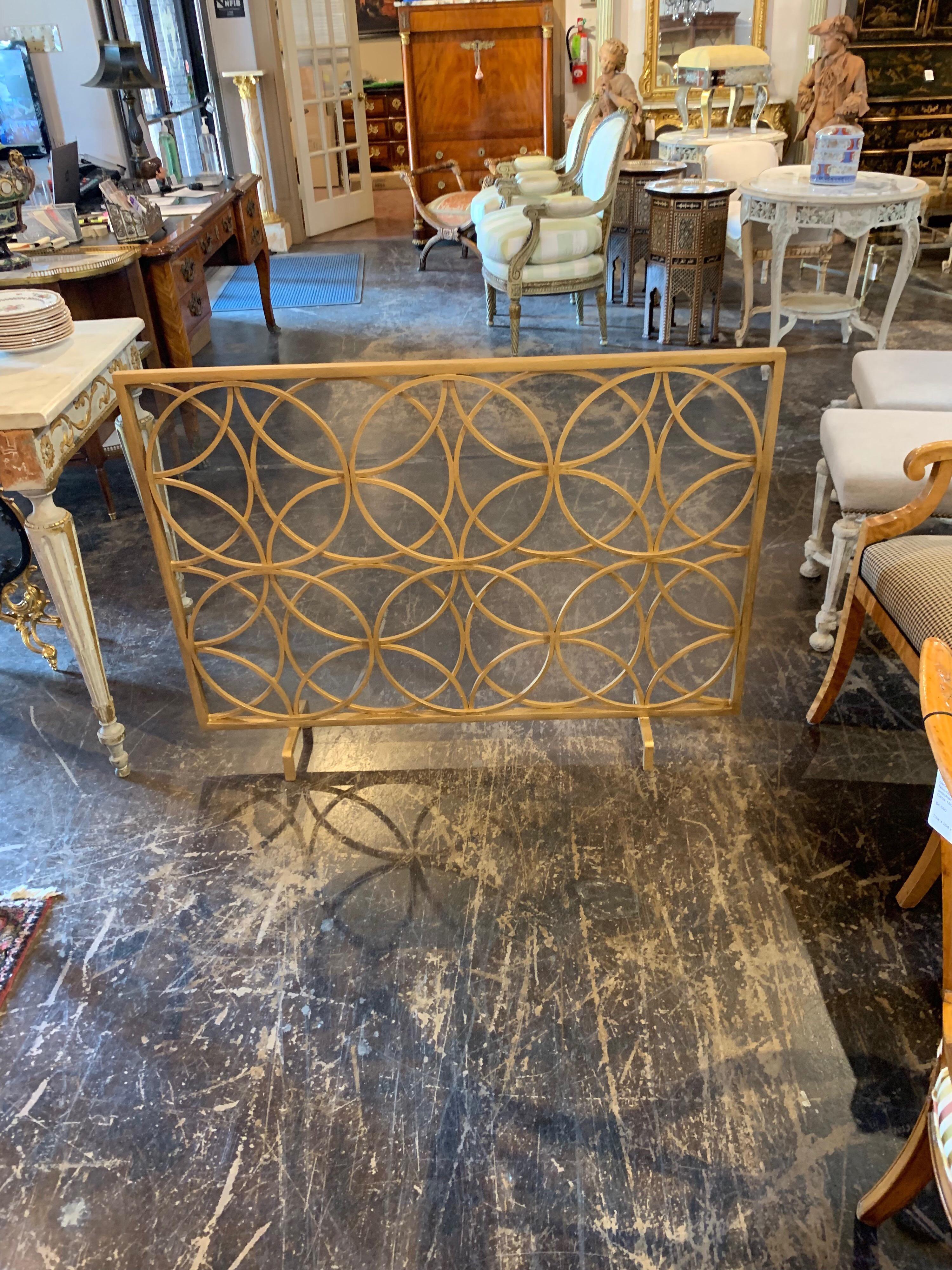 Beautiful modern style steel fire place screen custom made by Legacy. Circular pattern in gold gilt. Very special!